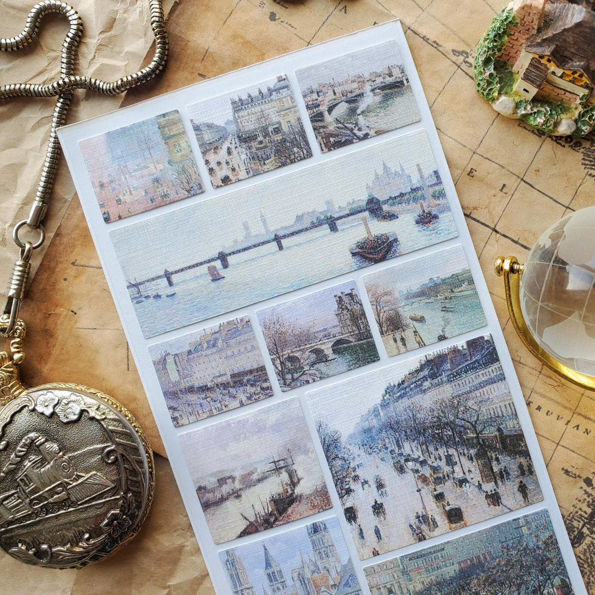 Sheet of scenic stickers with a vintage pocket watch and globe on a map background