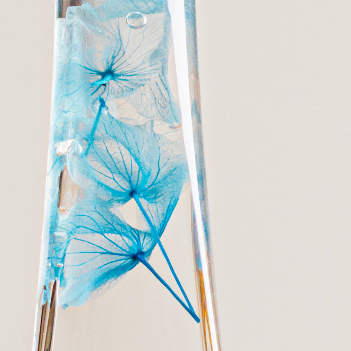 Decorative glass vase with blue floral design on a plain background