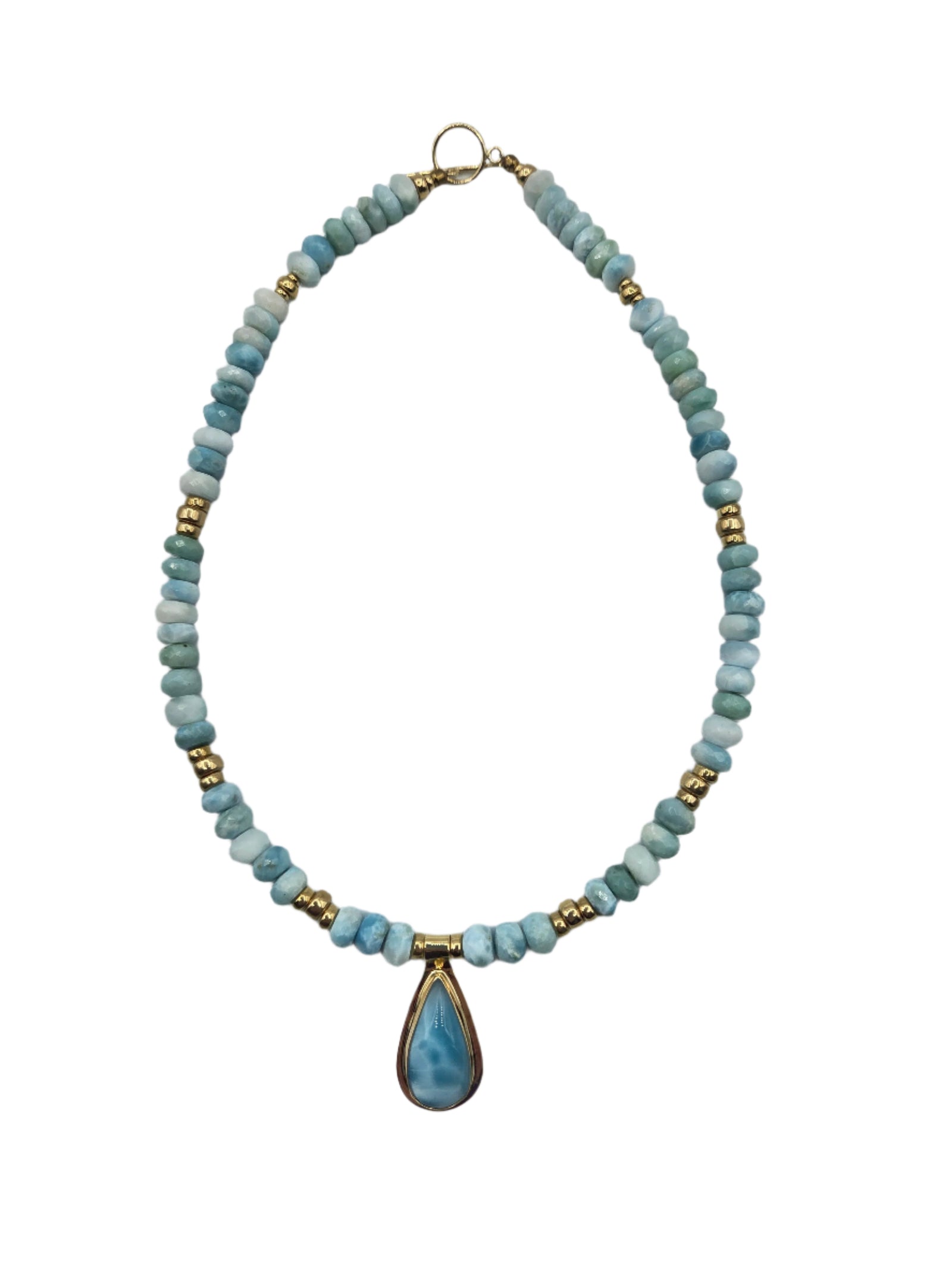 Necklace with blue beads and a gold teardrop pendant on a white background