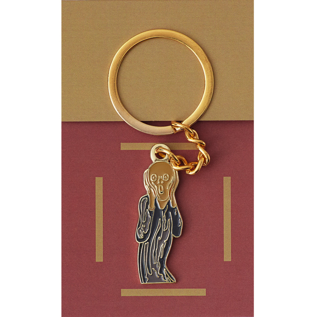 Gold keychain with a faceless figure pendant on a red and gold card