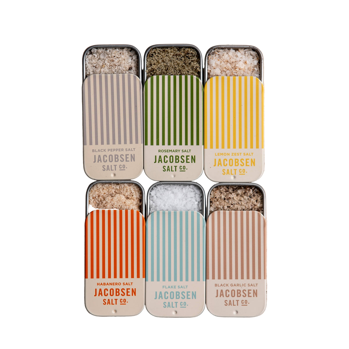 Set of Jacobsen Salt Co. salt containers on a textured beige surface