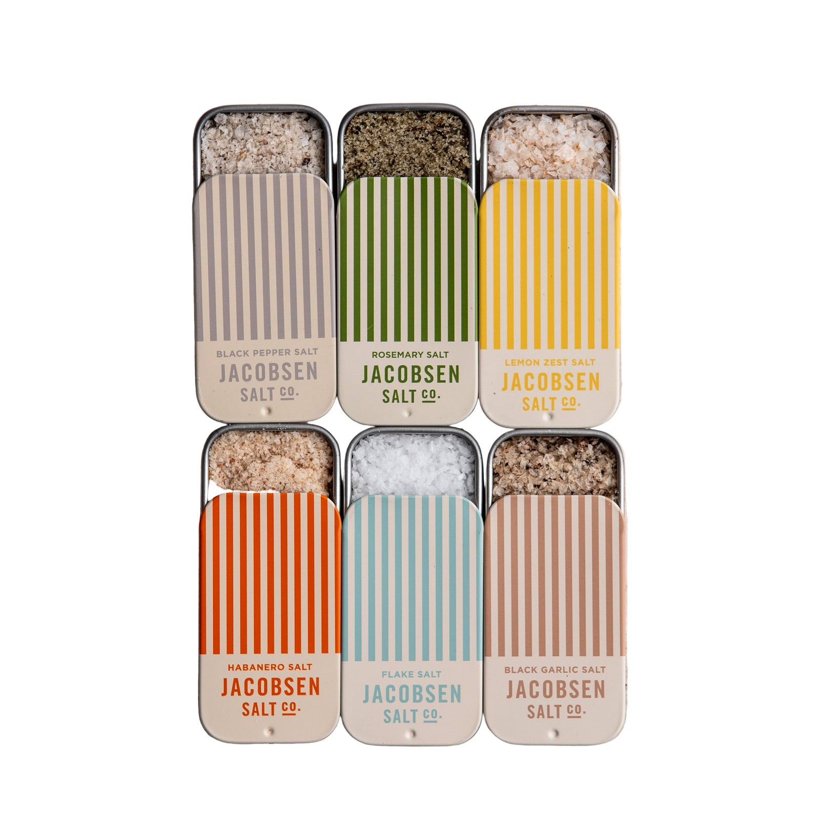 Set of Jacobsen Salt Co. salt containers on a textured beige surface