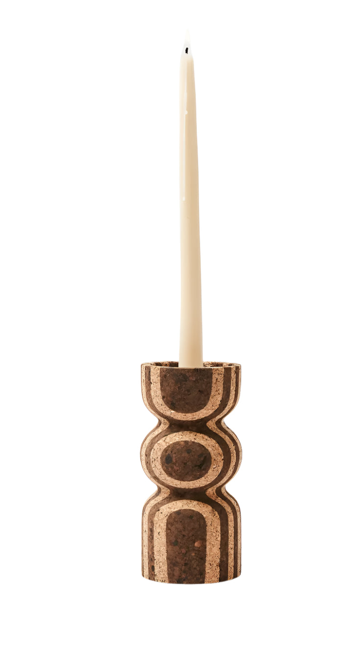 cork candle holder with a single candle on a white background