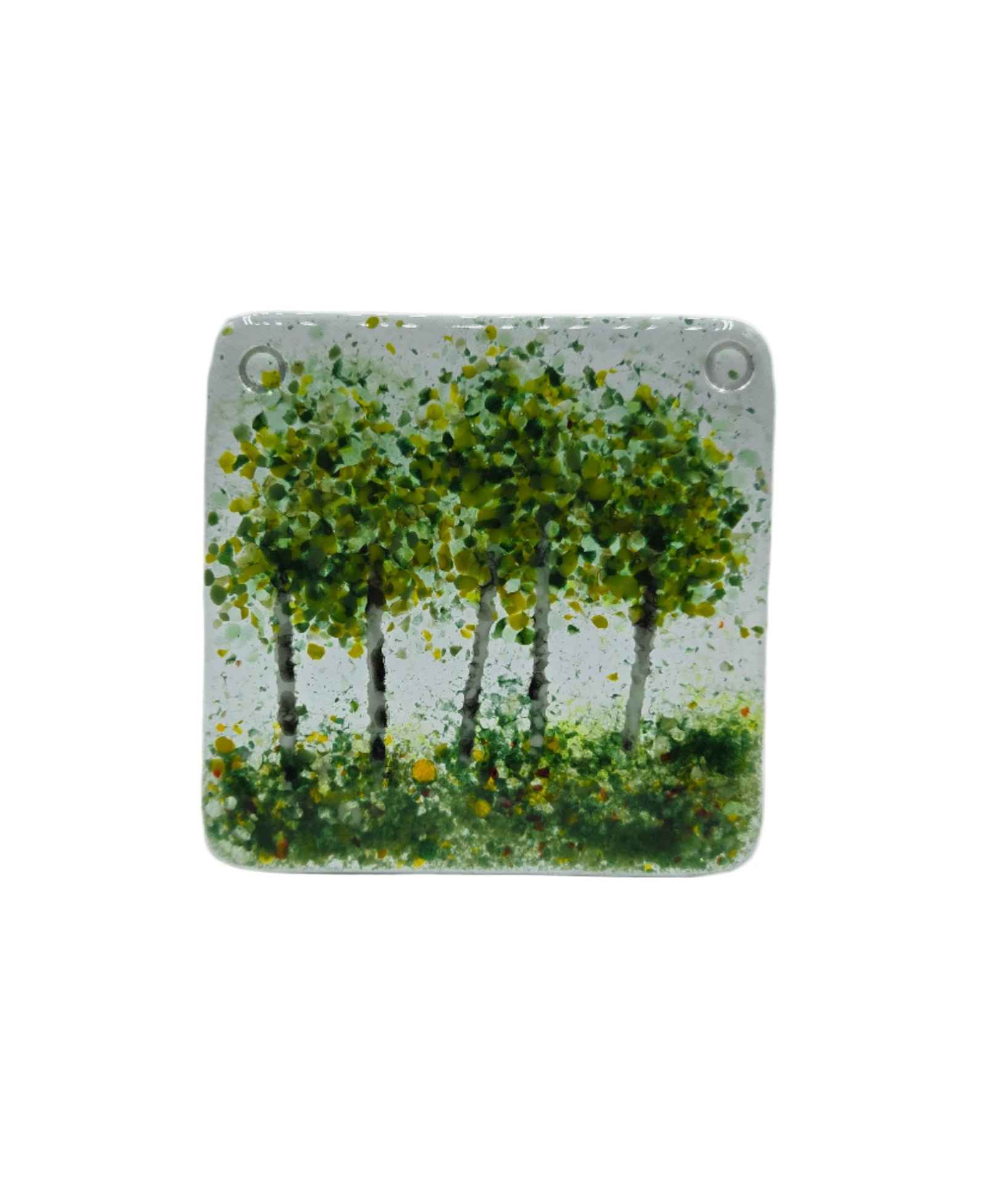 Decorative glass coaster with green trees on a white background