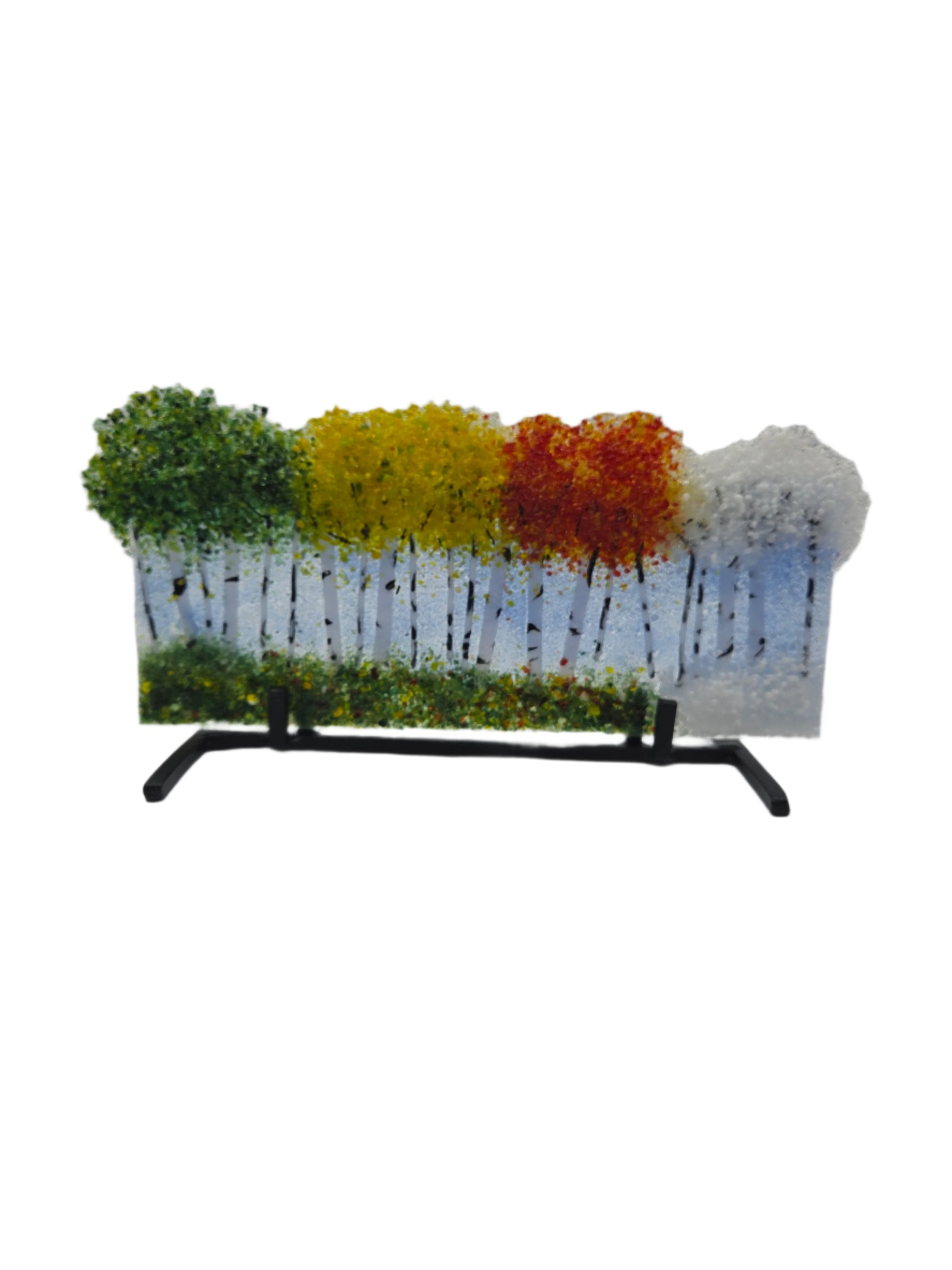 Decorative glass with green, yellow, red and white trees on a white background