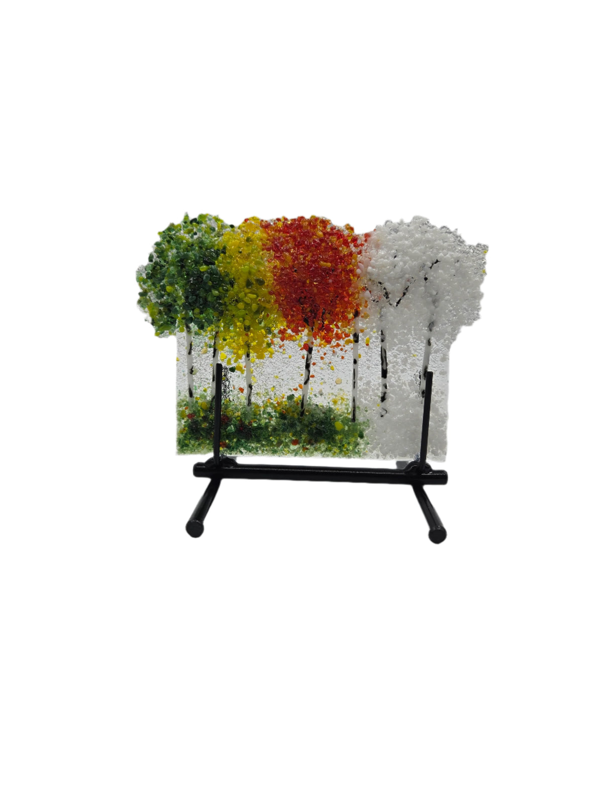 Decorative glass with green, yellow, red and white trees on a white background