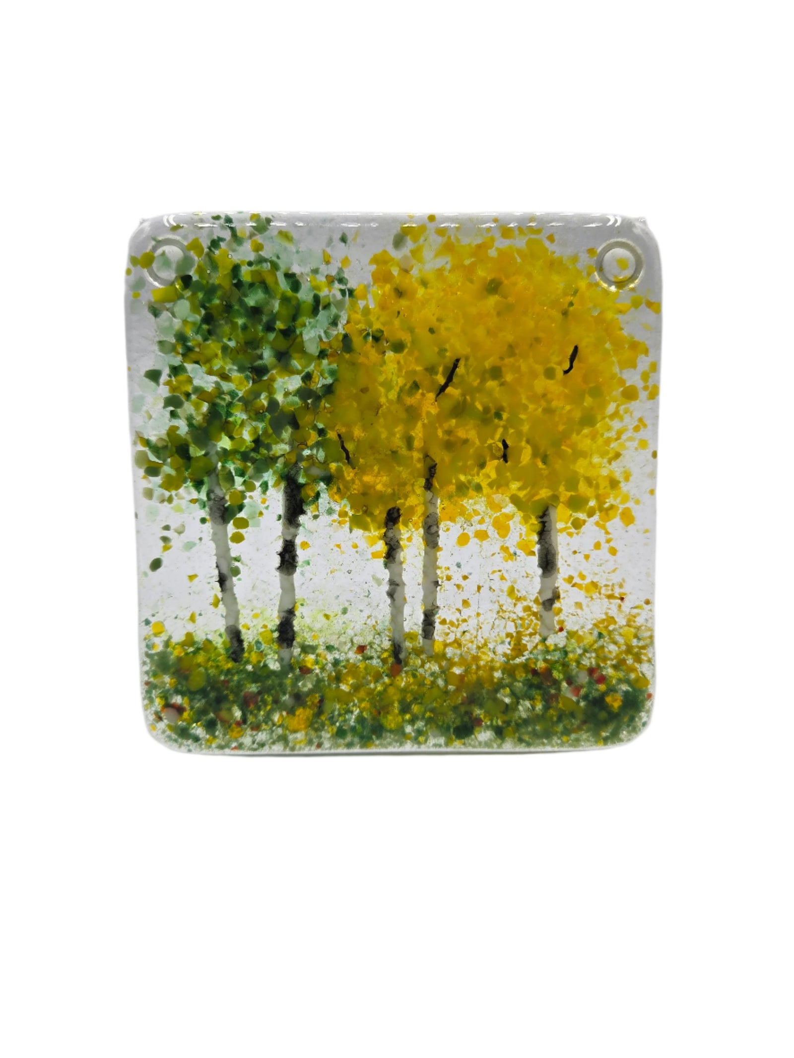 Square glass coaster with tree design in yellow and green on a white background