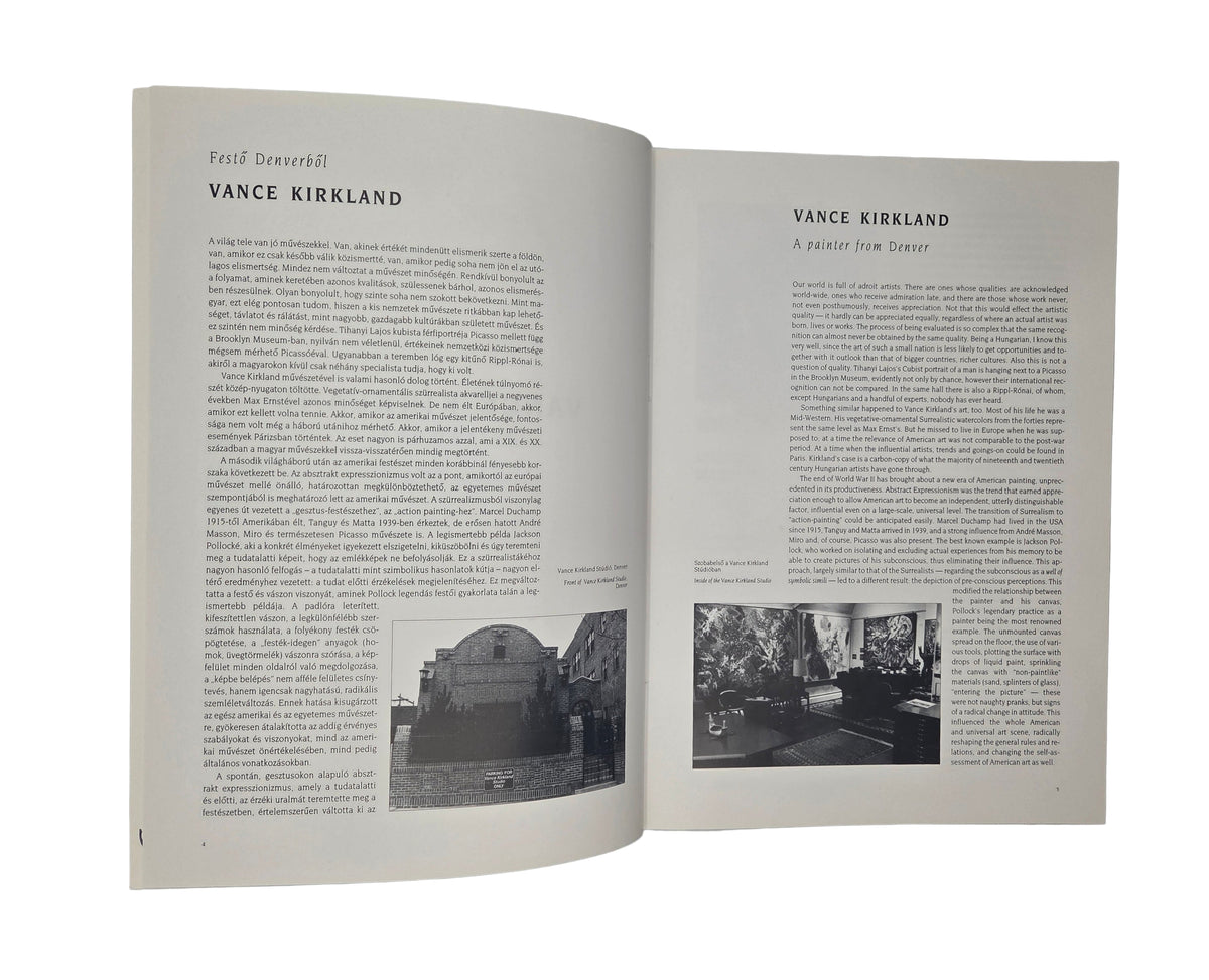 Open book with text and black and white photographs on a gray background