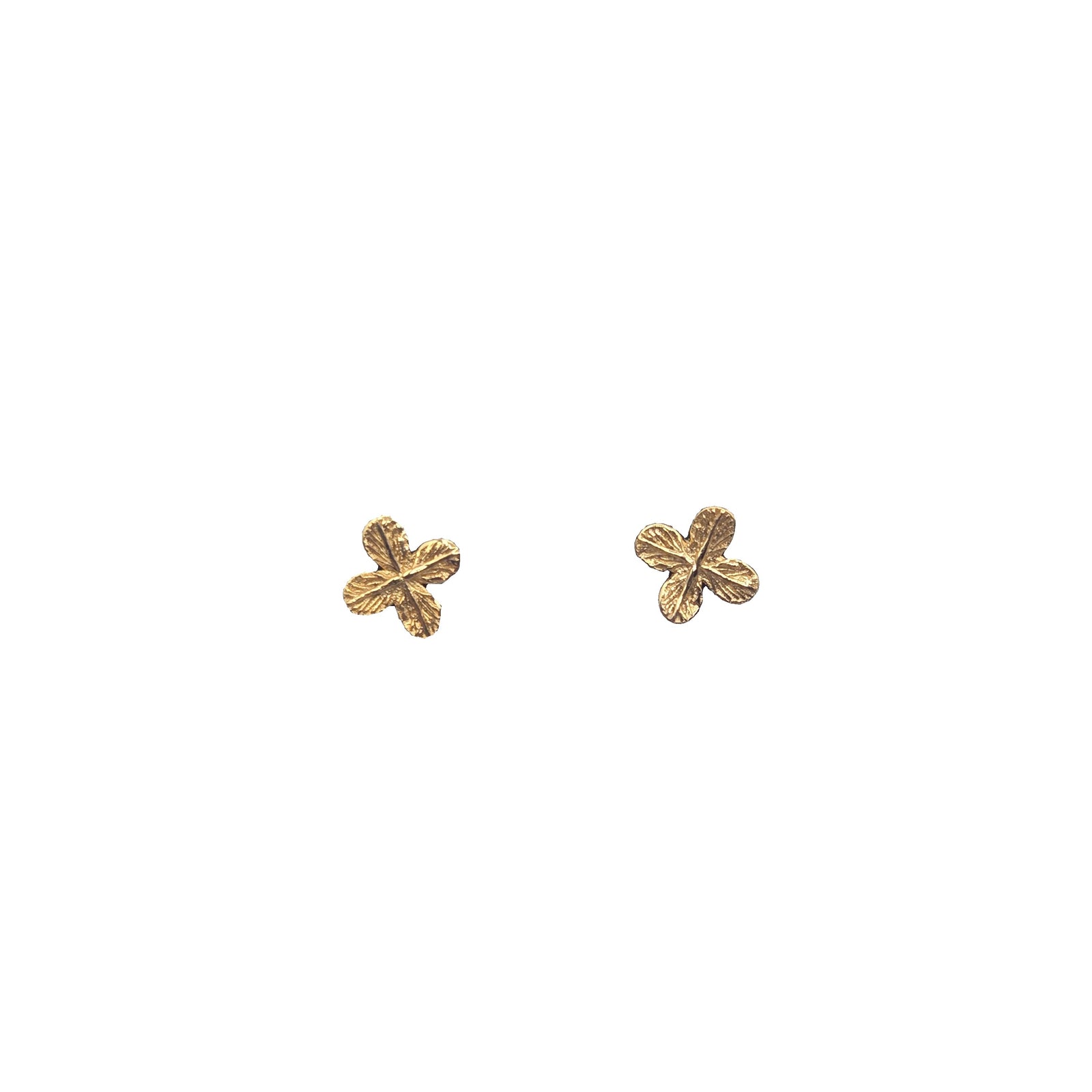 Gold flower-shaped earrings white background