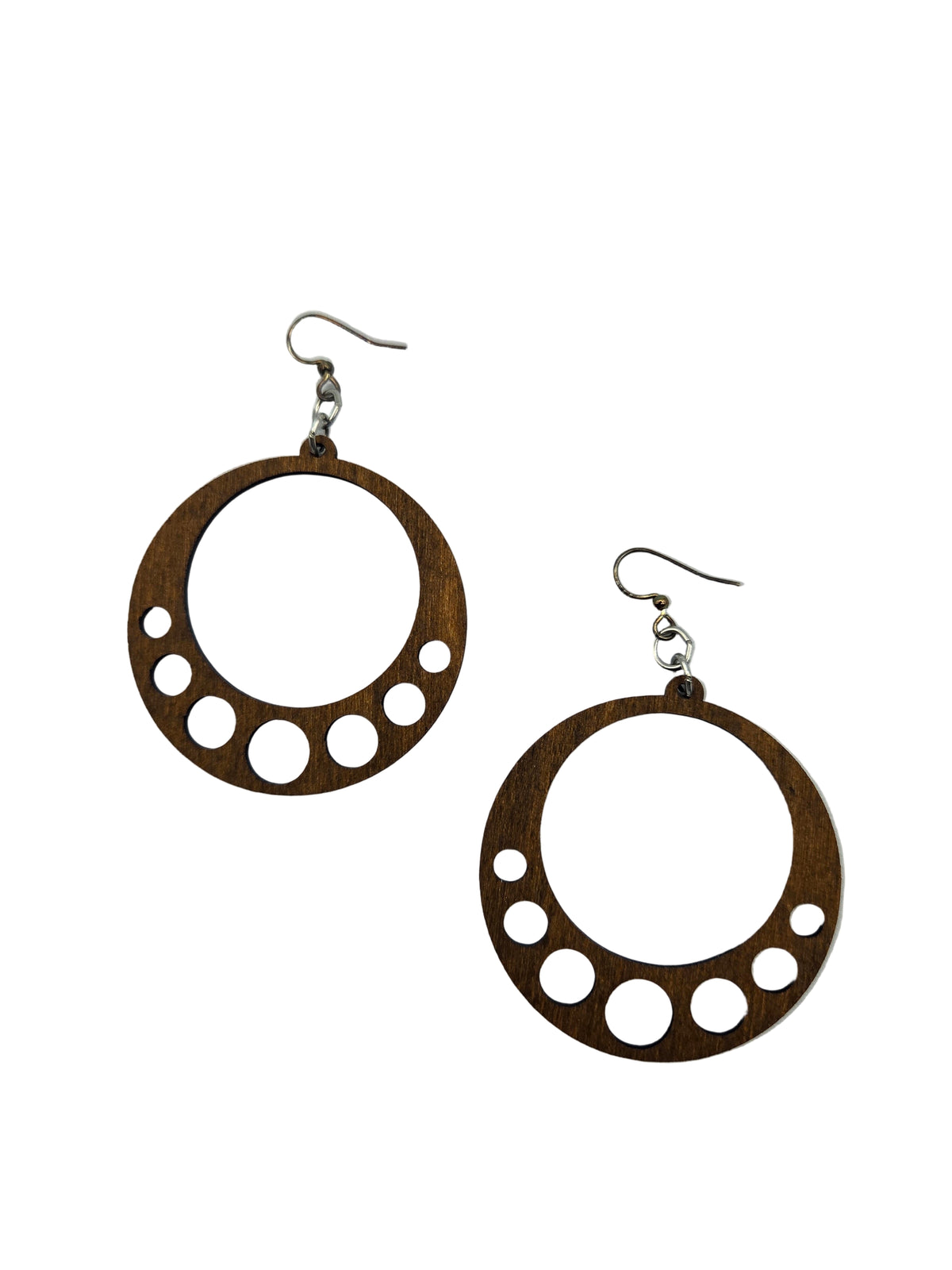 Wooden hoop earrings with circular cutouts on a white background