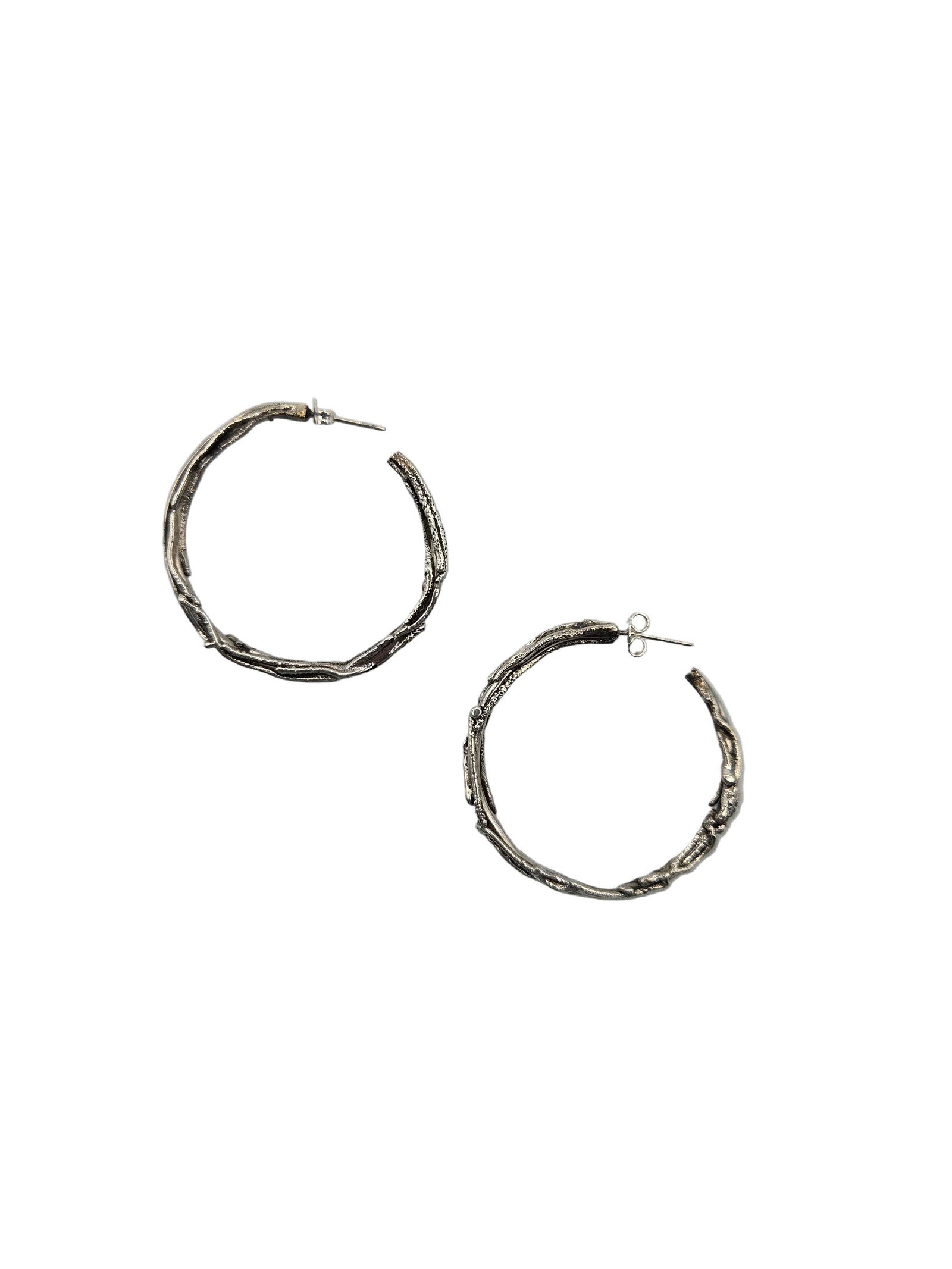 Pair of silver hoop earrings on a white background