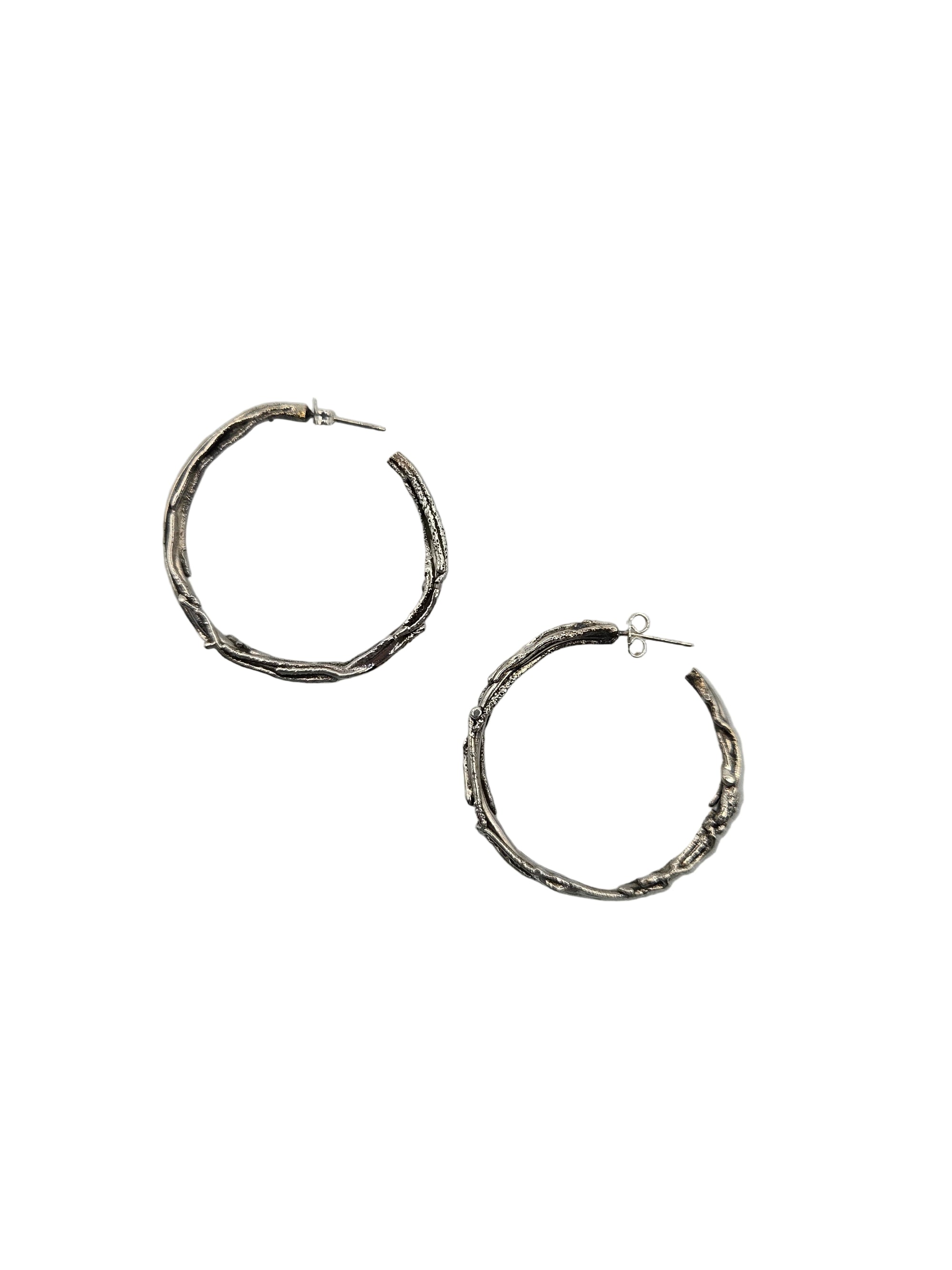 Pair of silver hoop earrings on a white background
