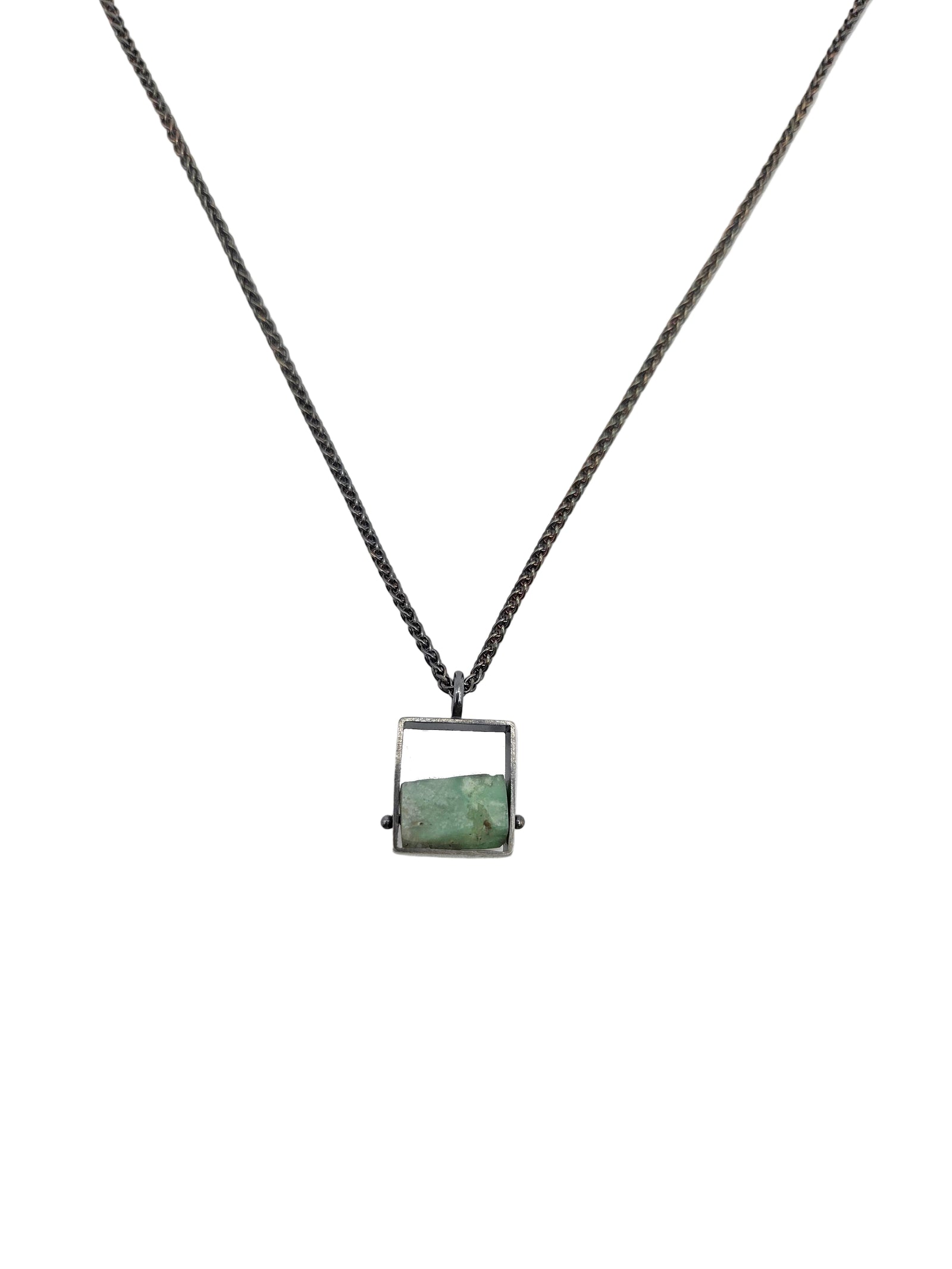 Square silver necklace with a chunky blue stone.