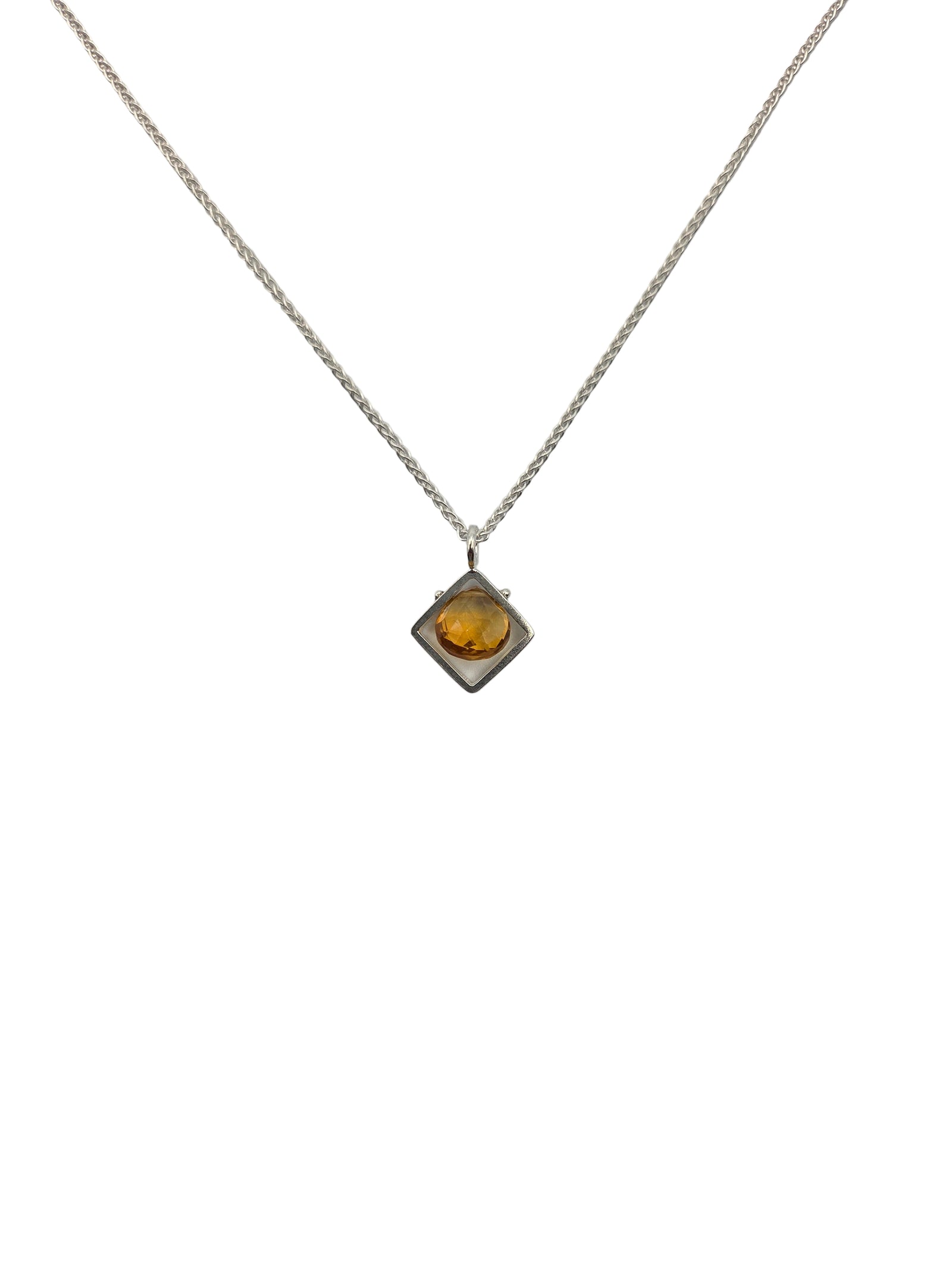 Necklace with a square pendant featuring a yellow gemstone on a white background