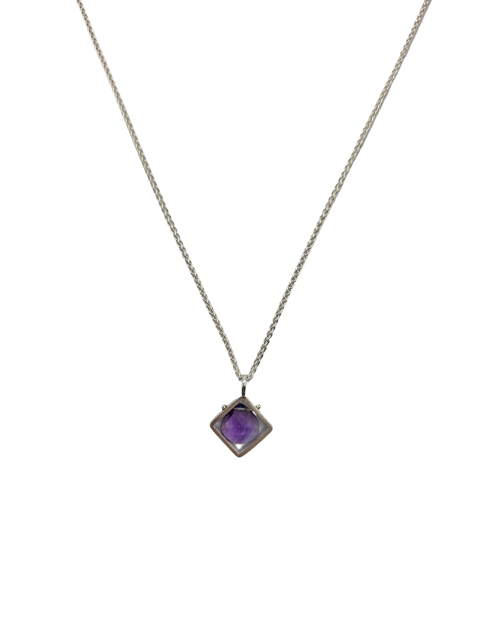 Necklace with a purple gemstone pendant on a plain background