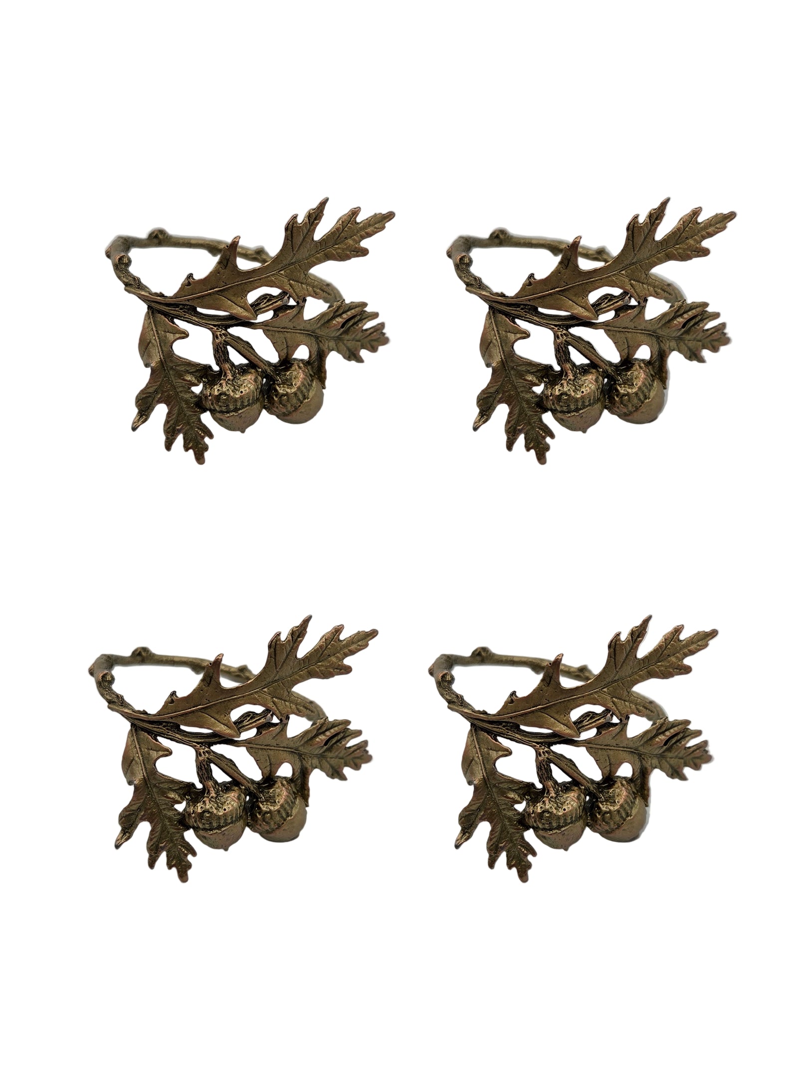 Four ornate bronze objects with leaf and acorn design on a gray background
