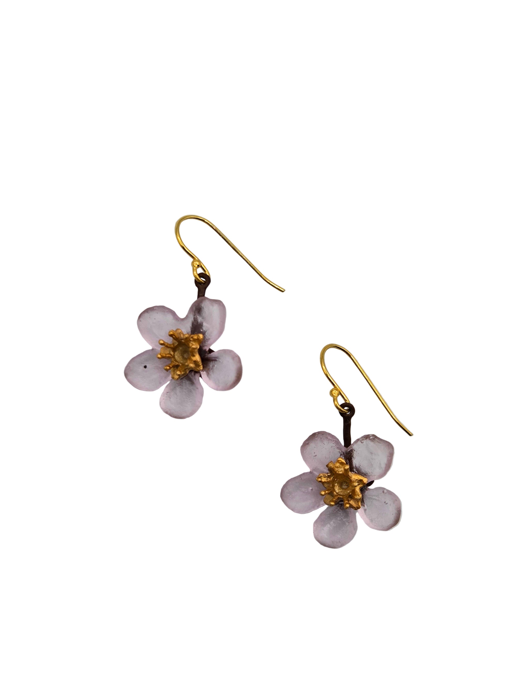 Flower-shaped earrings with gold centers on awhitebackground