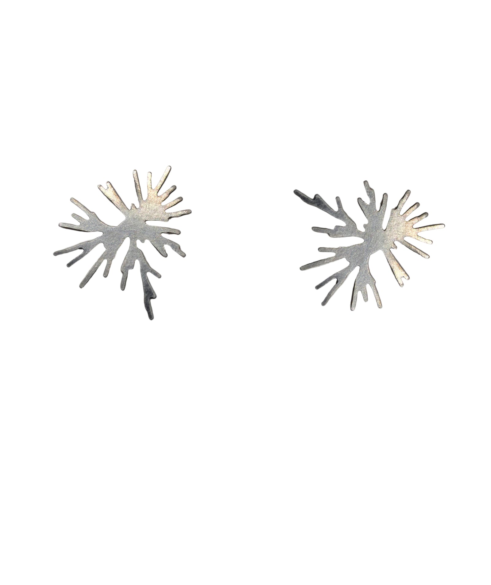 Pair of silver starburst earrings on a white background