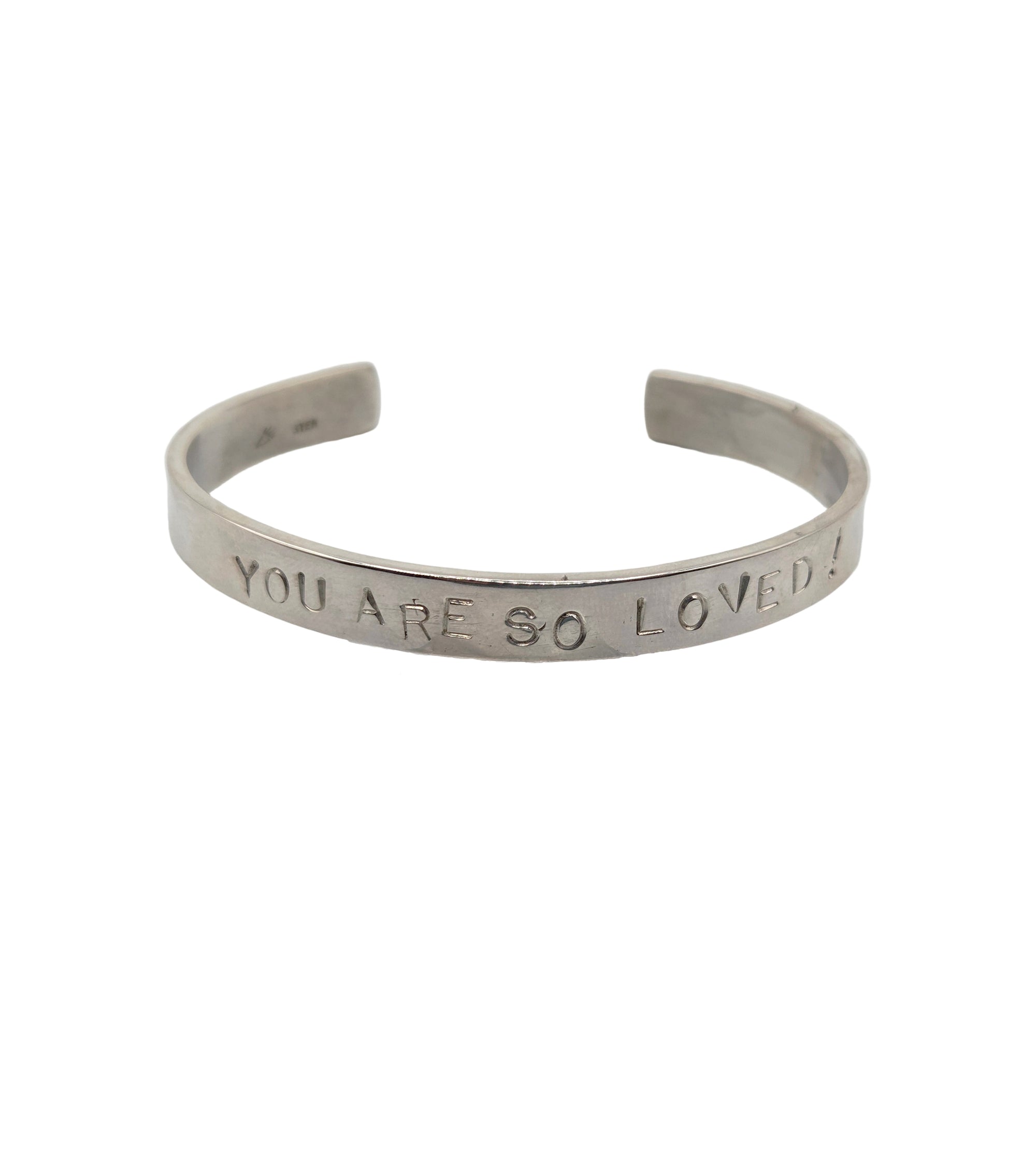 Silver bracelet with 'YOU ARE SO LOVED' engraving on a white background