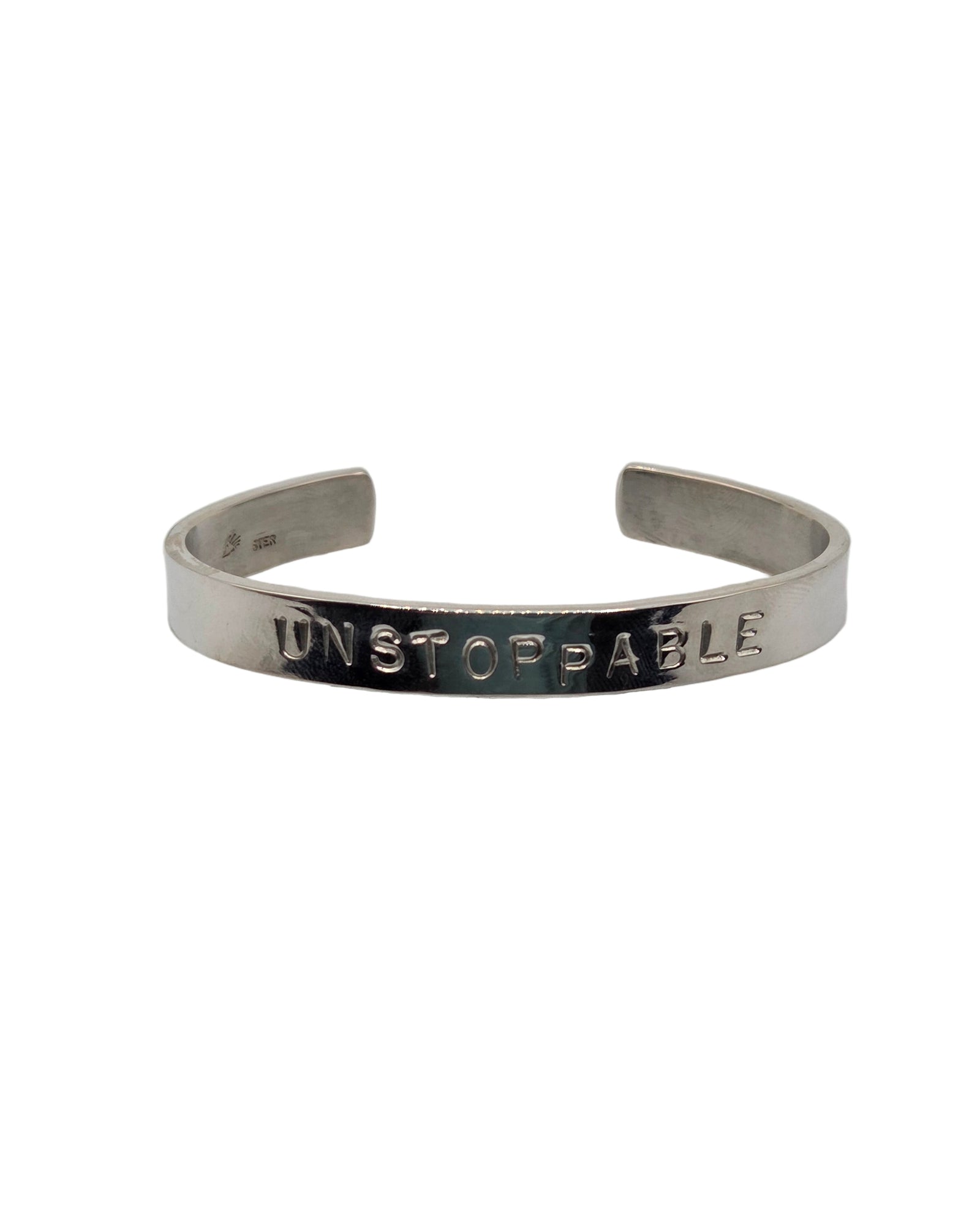 Silver bracelet with 'UNSTOPPABLE' engraving on a white background
