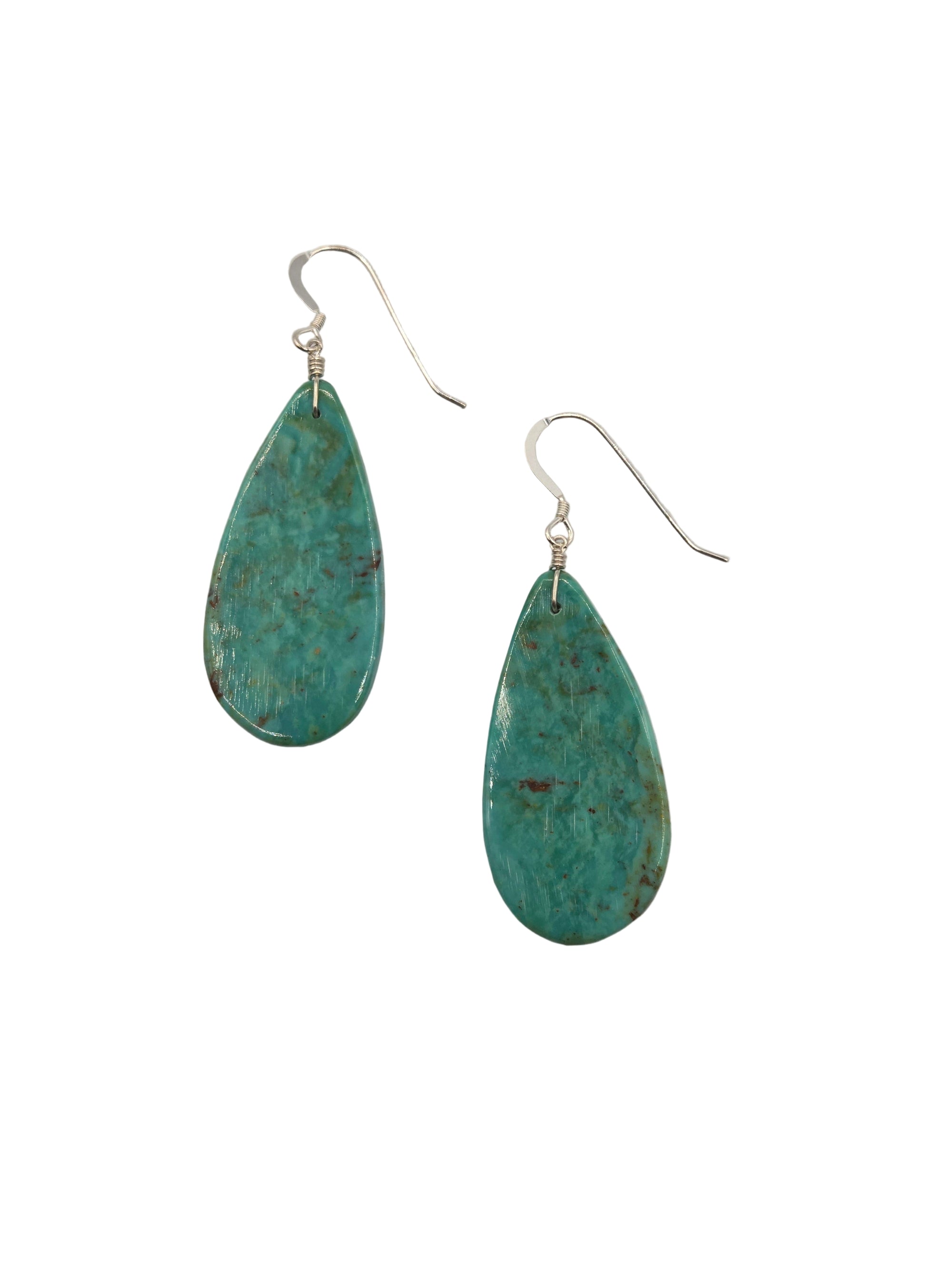 Pair of turquoise teardrop earrings on a white background