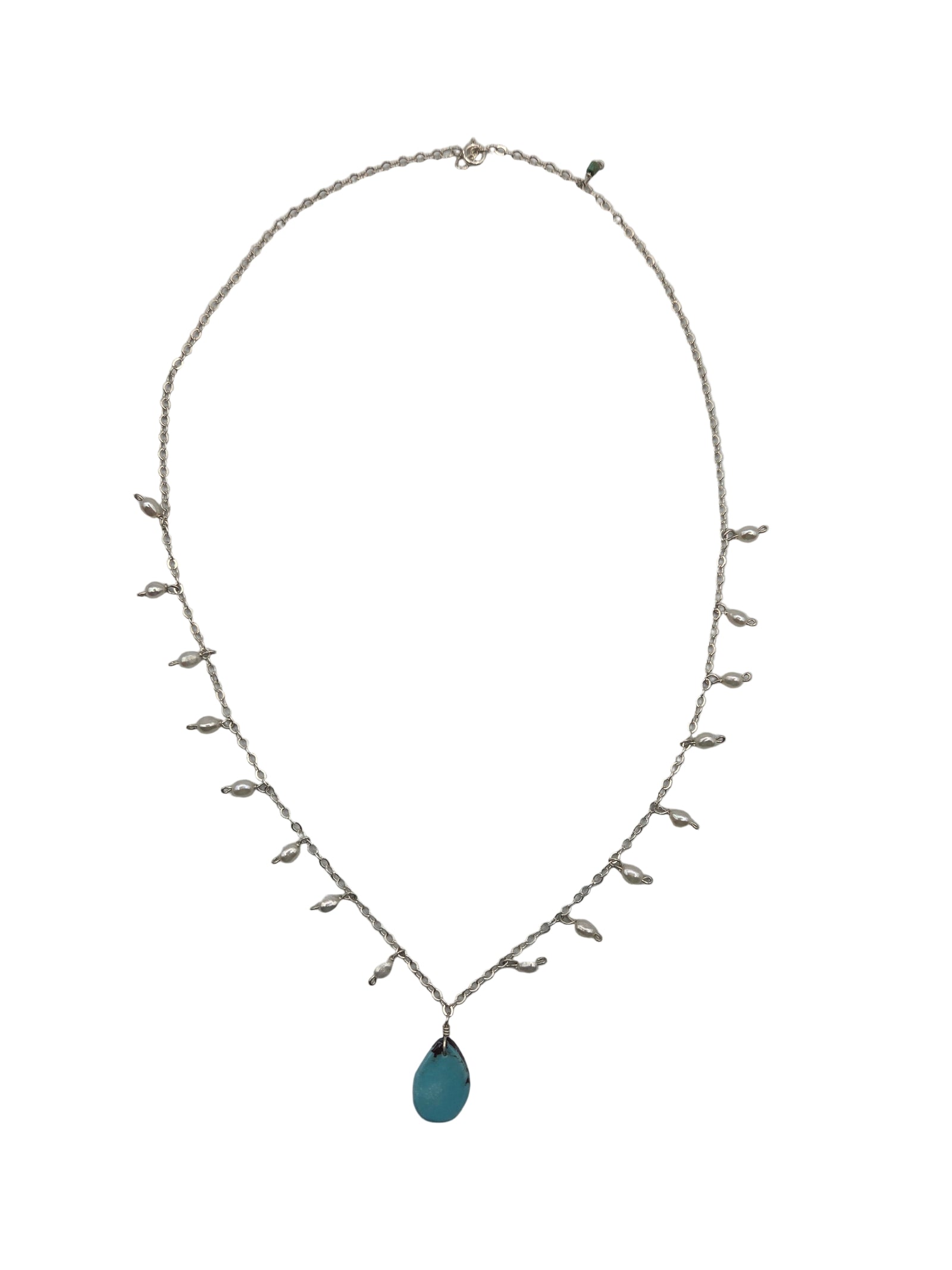 Delicate necklace with pearls and a blue stone on a white background