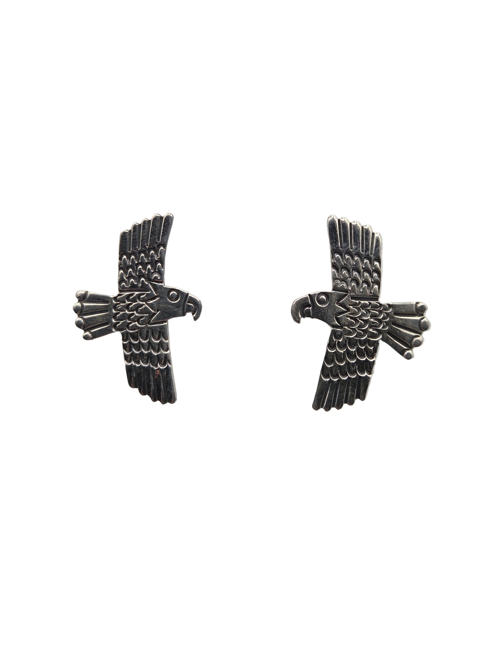 Pair of silver eagle earrings on a white background