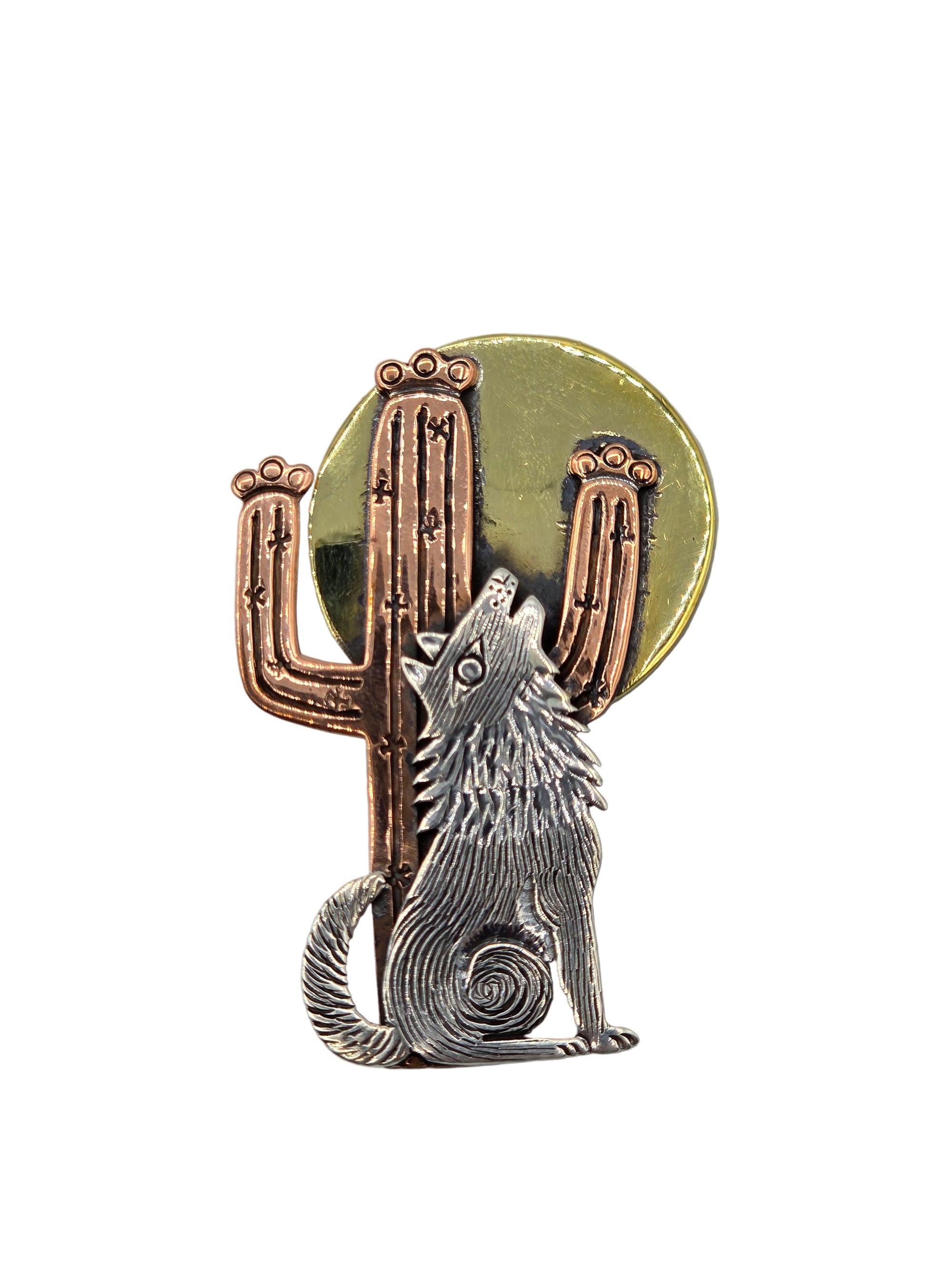 Silver wolf sitting in front of a copper cactus with a bronze moon brooche
