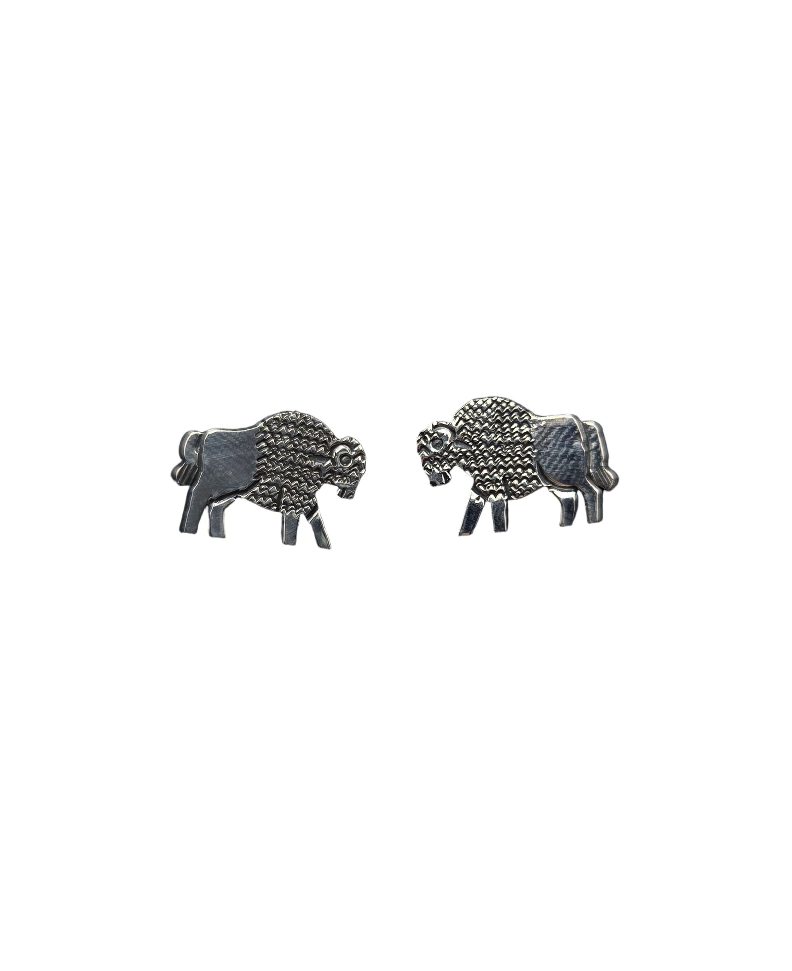Pair of silver buffalo earrings on a white background