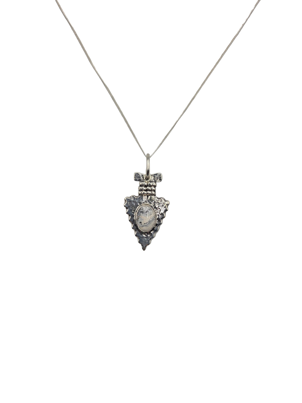 Silver arrowhead pendant with white and black stone