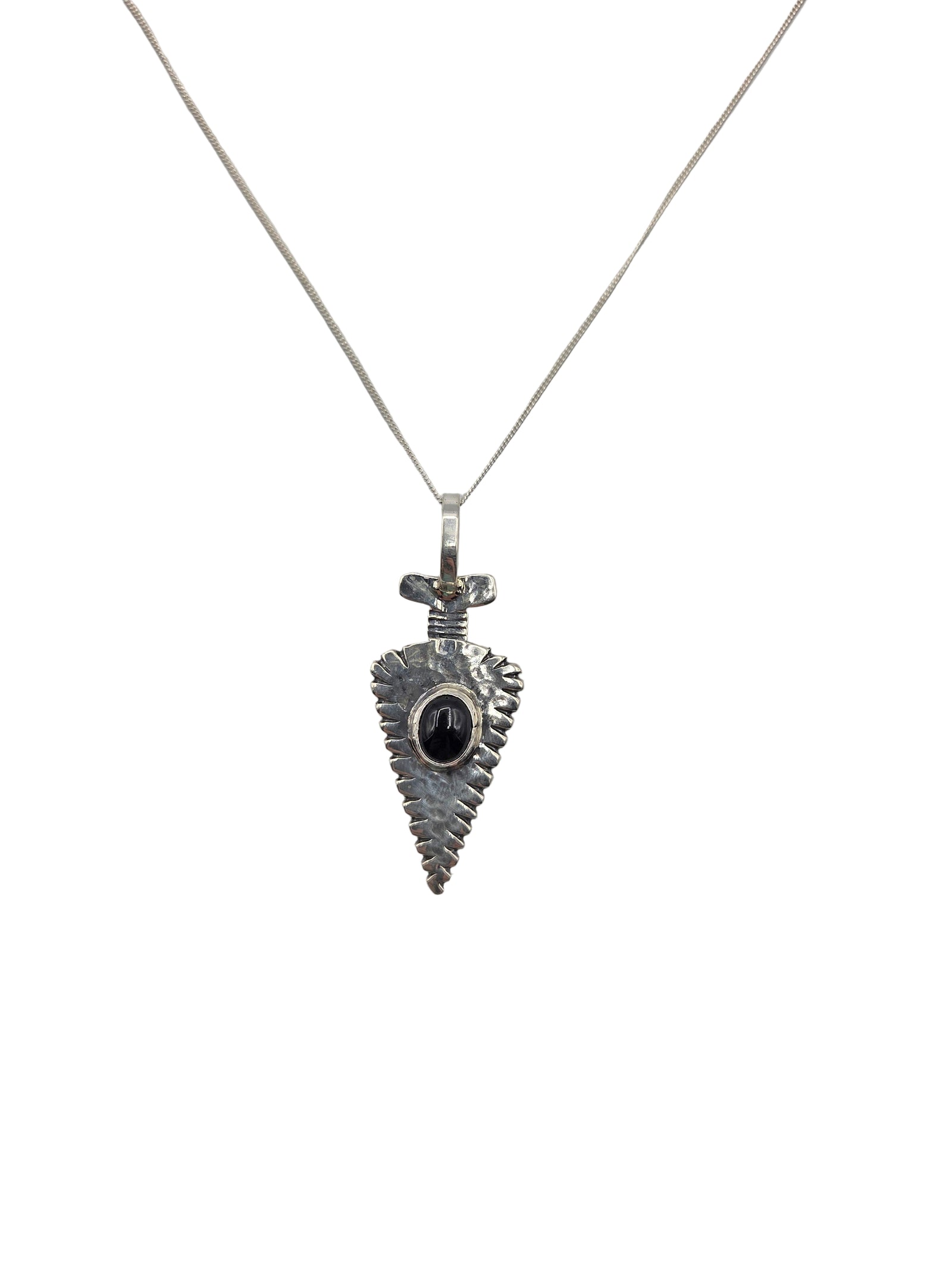 Silver arrowhead pendant necklace with a black stone on a white background