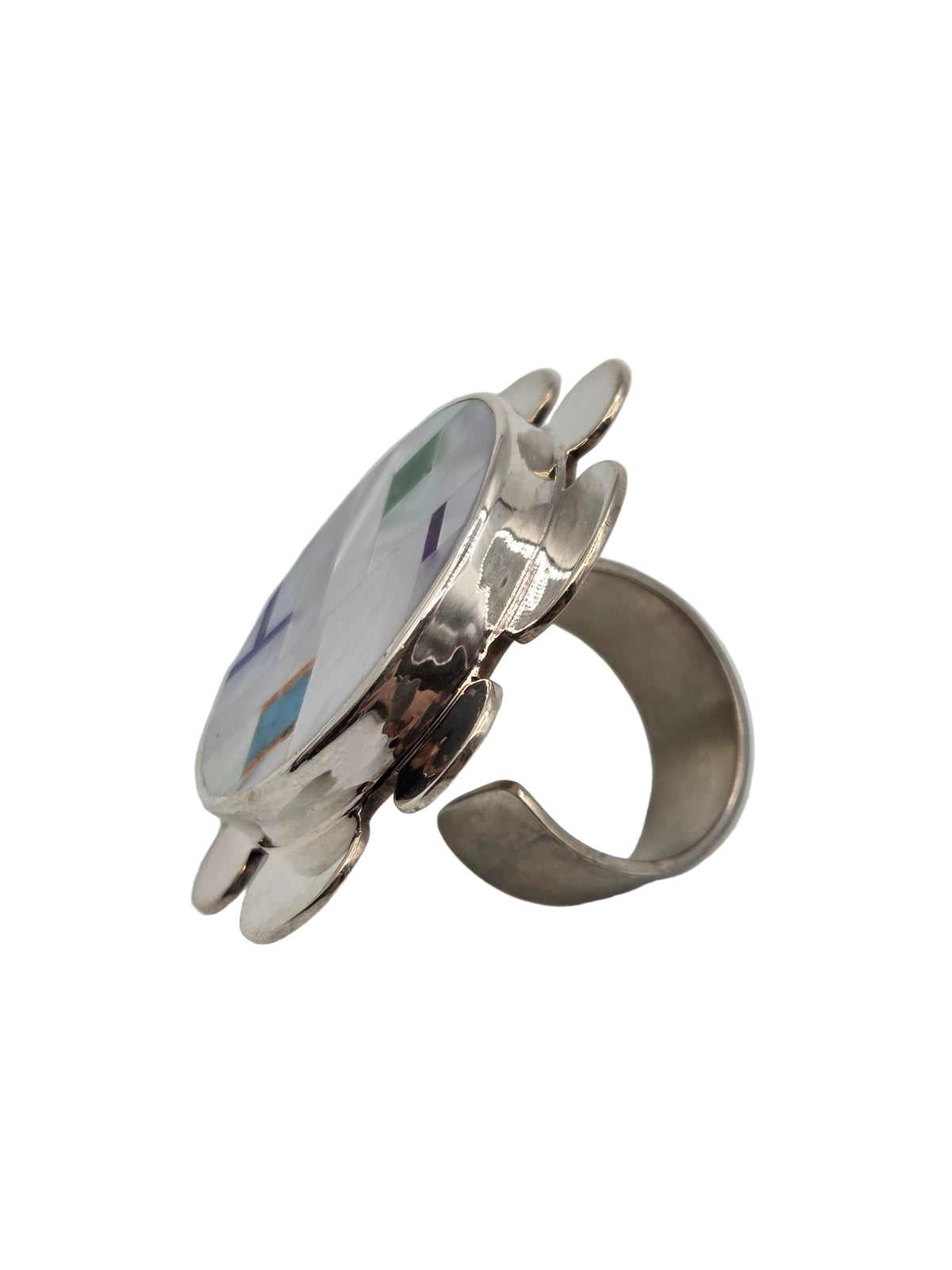 Silver ring with a colorful circular design on a white background