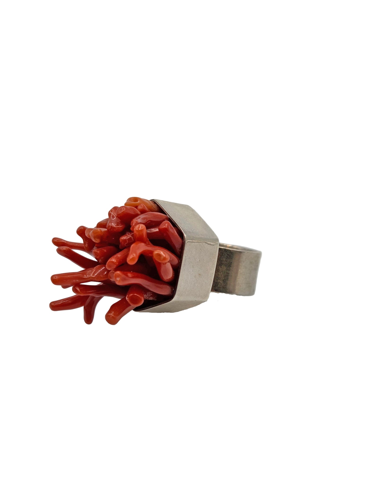 Ring with red coral-like structure on a white background
