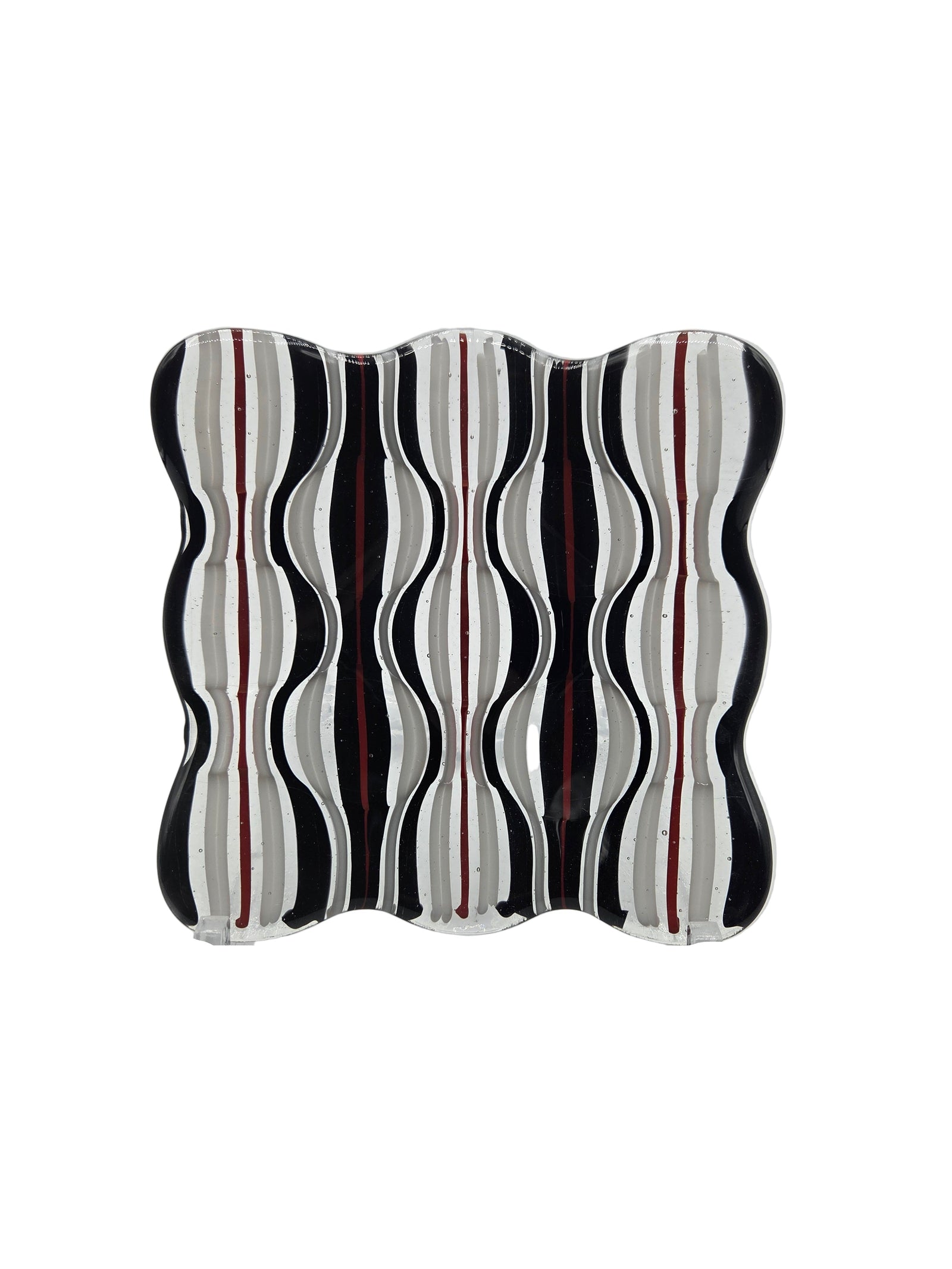 Decorative glass with wavy black and white design on a white background