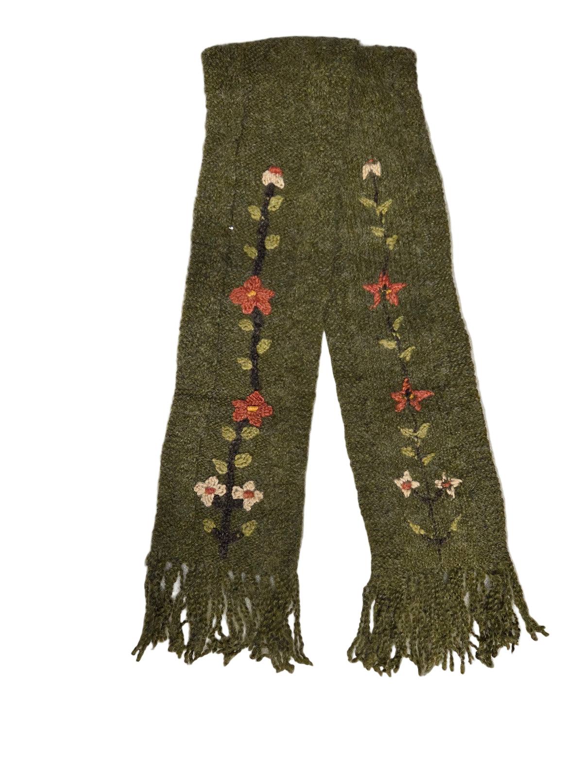 Green knitted scarf with floral patterns on a white surface