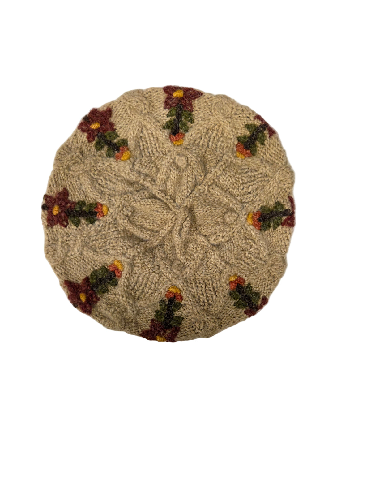 Beige embroidered hat with flowers on a white surface