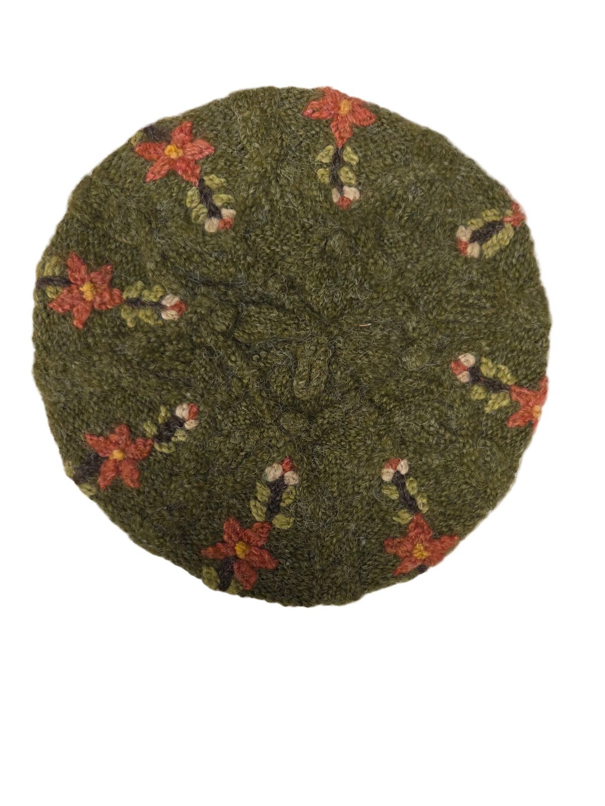 Green embroidered hat with flowers on a white surface