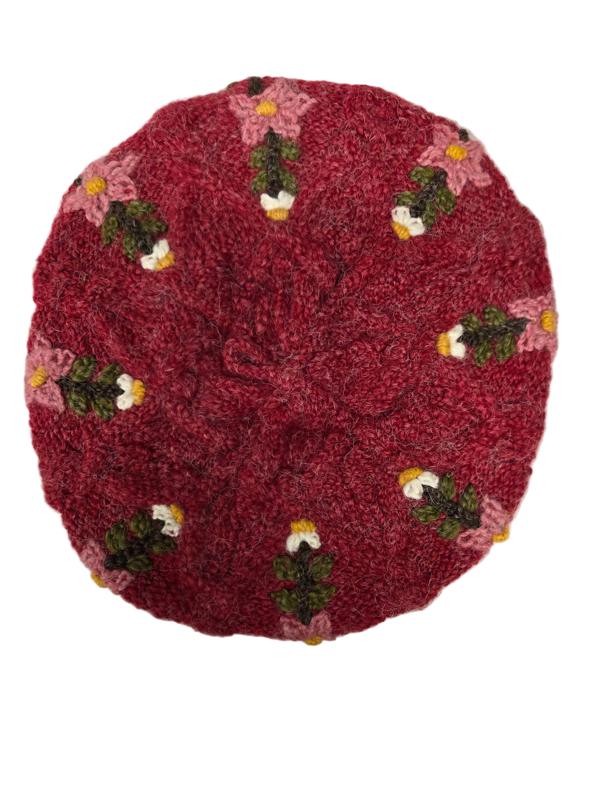 Red embroidered hat with flowers on a white surface