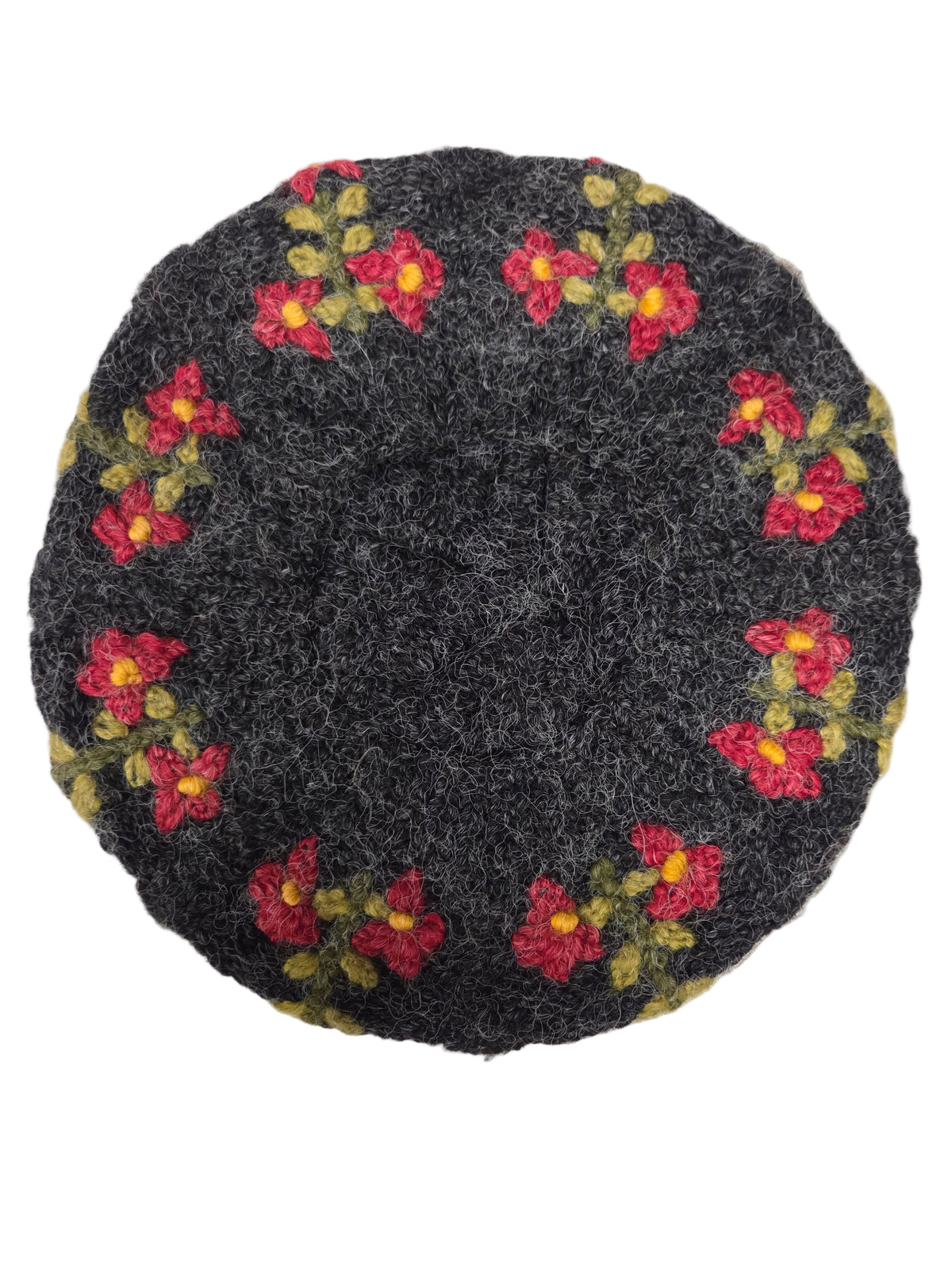 Black embroidered hat with flowers on a white surface