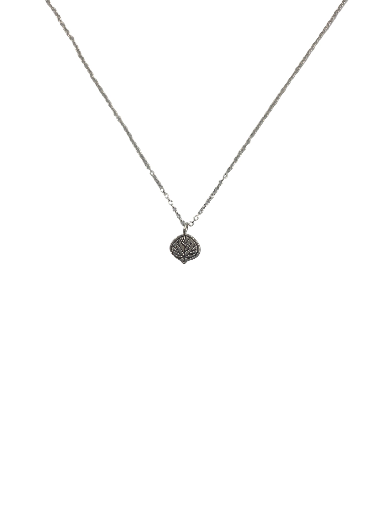 Silver necklace with a leaf pendant on a light gray background