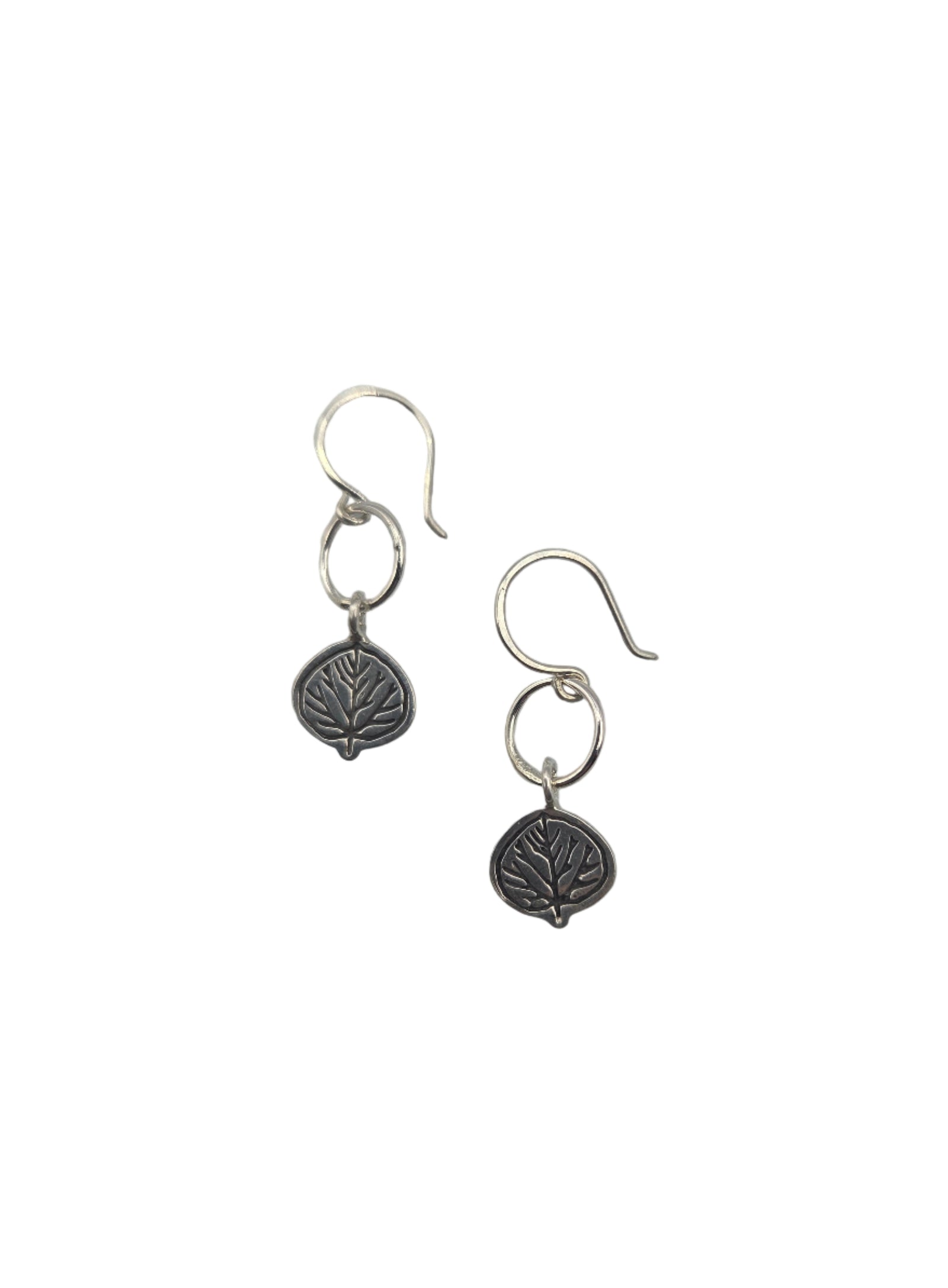 Pair of silver leaf earrings on a white background