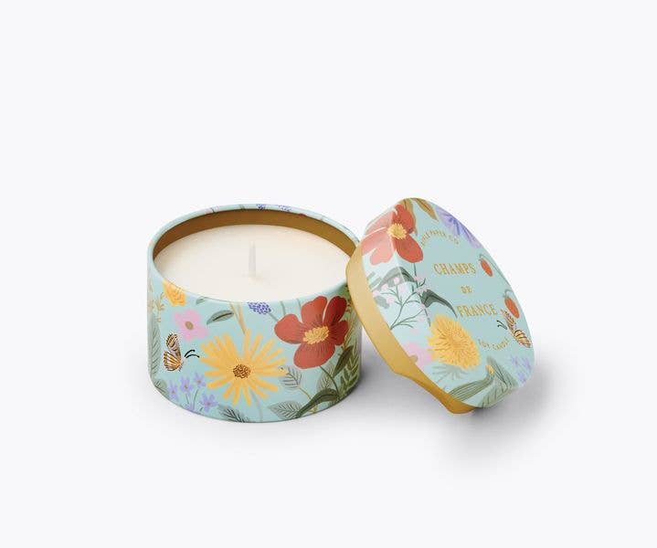 Floral-patterned candle in a tin with lid on a white background