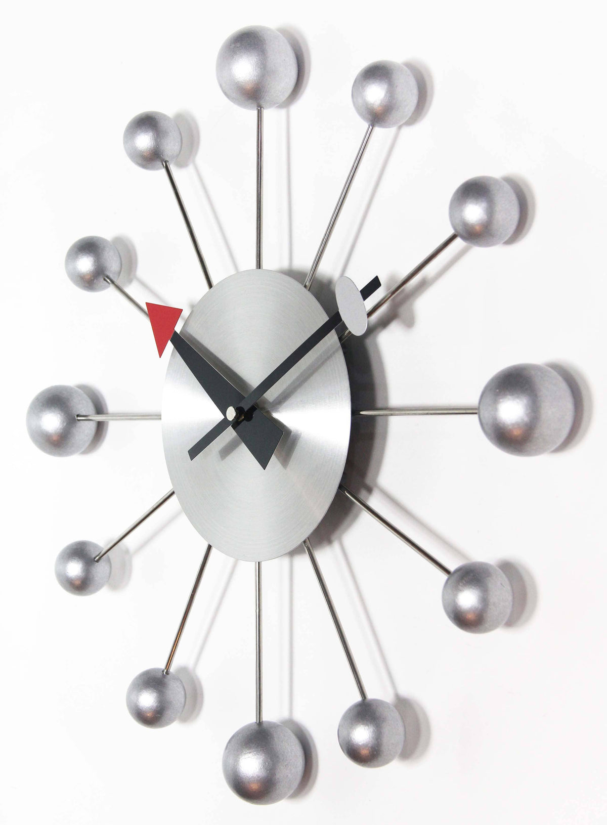 Modern wall clock with spherical design on a white background