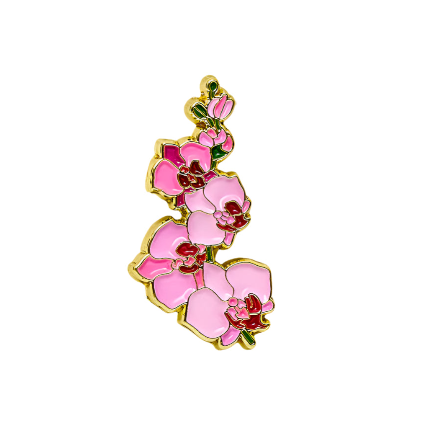 Pink orchid-shaped pendant on a beige fabric background