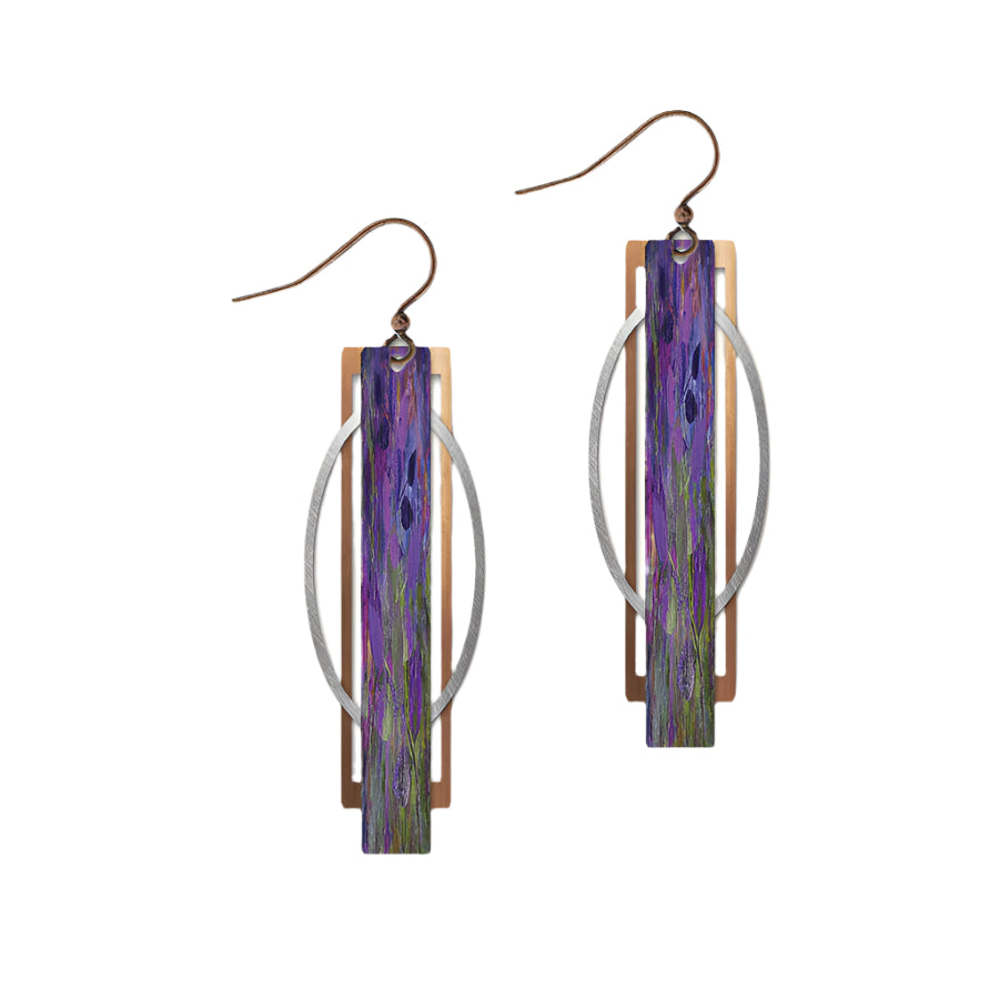 Pair of earrings with purple and green design on a beige background