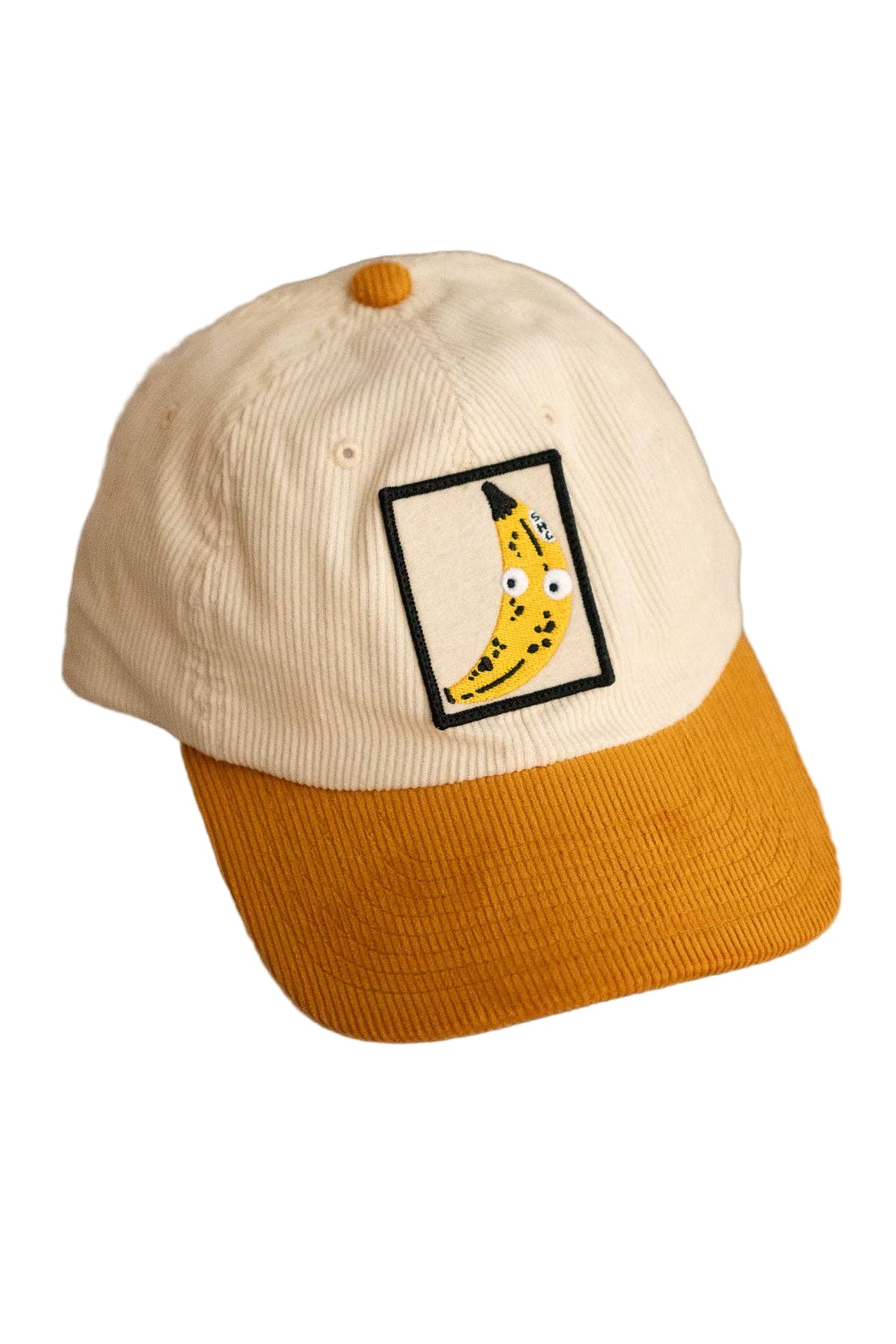 Cap with a banana graphic on a neutral background