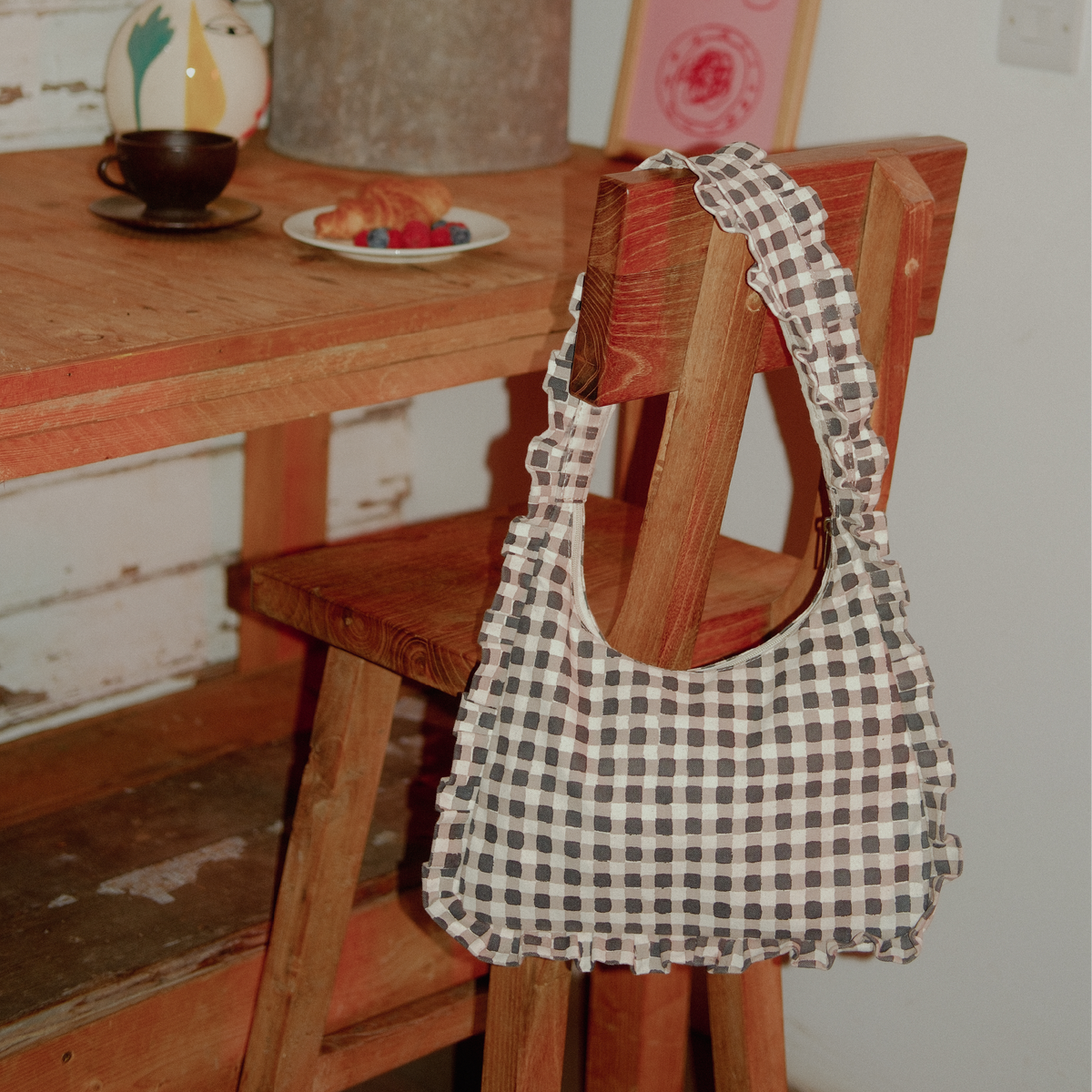 Checkered bag on a wooden chair with a rustic background