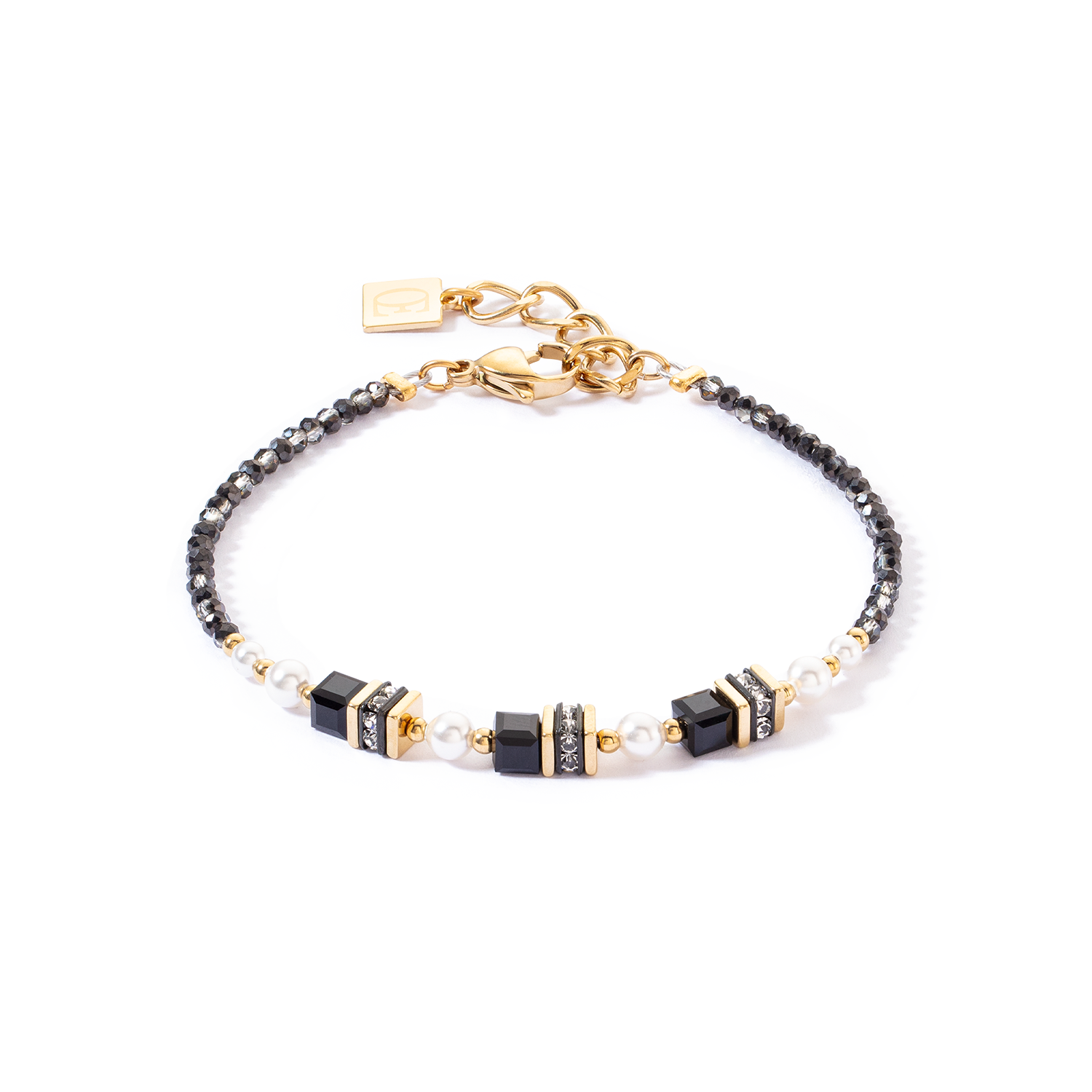 Bracelet with black, gold, and pearl beads on a white background