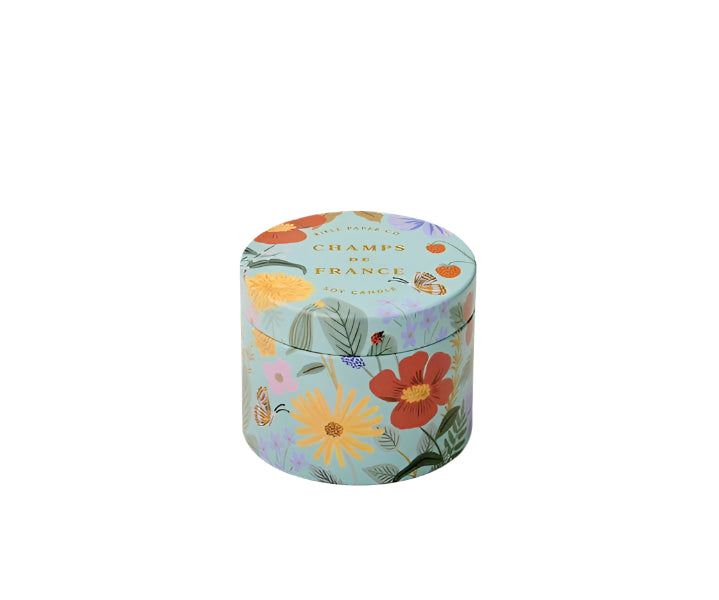 Round decorative tin with yellow, orange, purple, pink, and green floral design on a white background