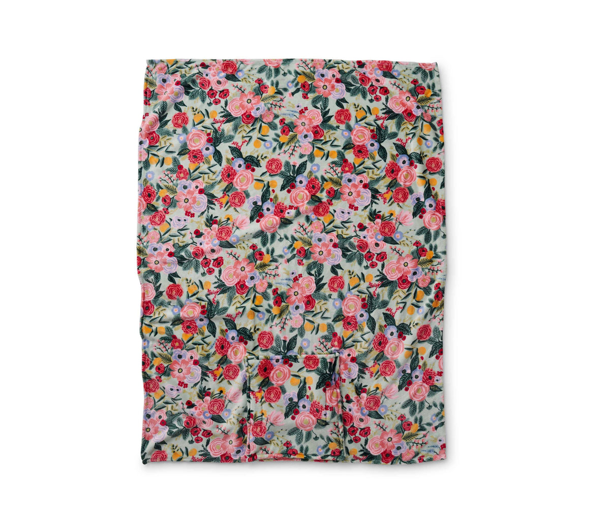 Floral (pinks, reds, blues, greens) patterned blanket on a white background